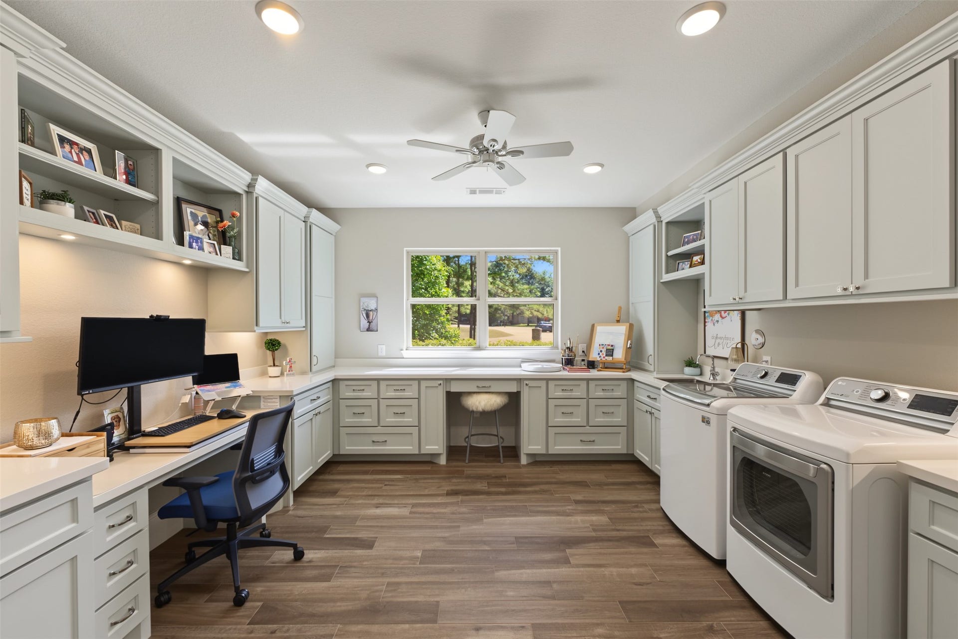 501 Corsair Court, Montgomery, TX 77316 Utility room aptly named. Keep your eye on laundry, deliveries and craft away or manage work and home from this beautiful multipurpose room with many custom cabinet features. Double pocket doors allow for a quiet work space.