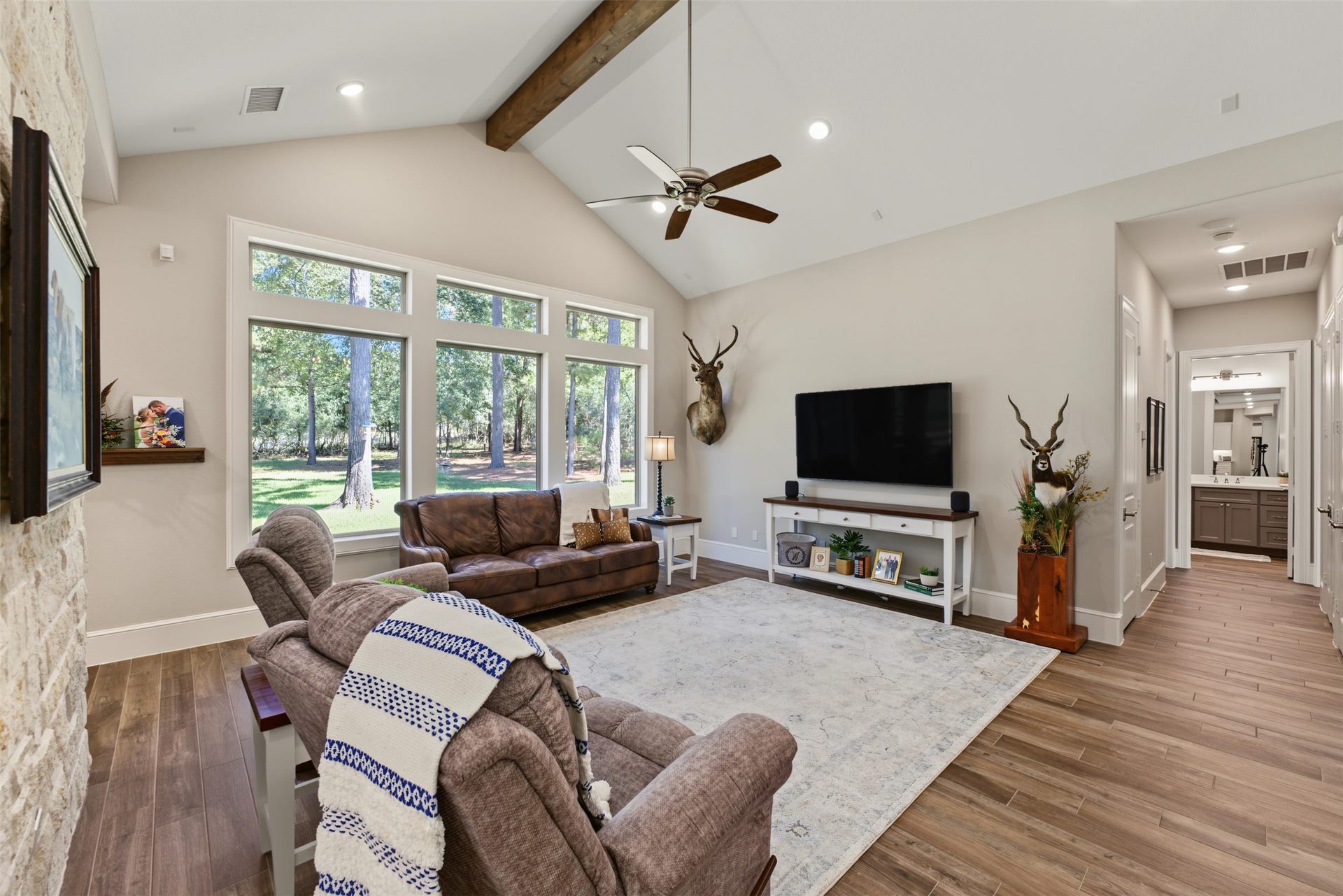 501 Corsair Court, Montgomery, TX 77316 Welcome to the view sitting in your vaulted cedar beamed living room. To the right of the living room is the hallway lined with closets for storage to the secondary bedrooms.