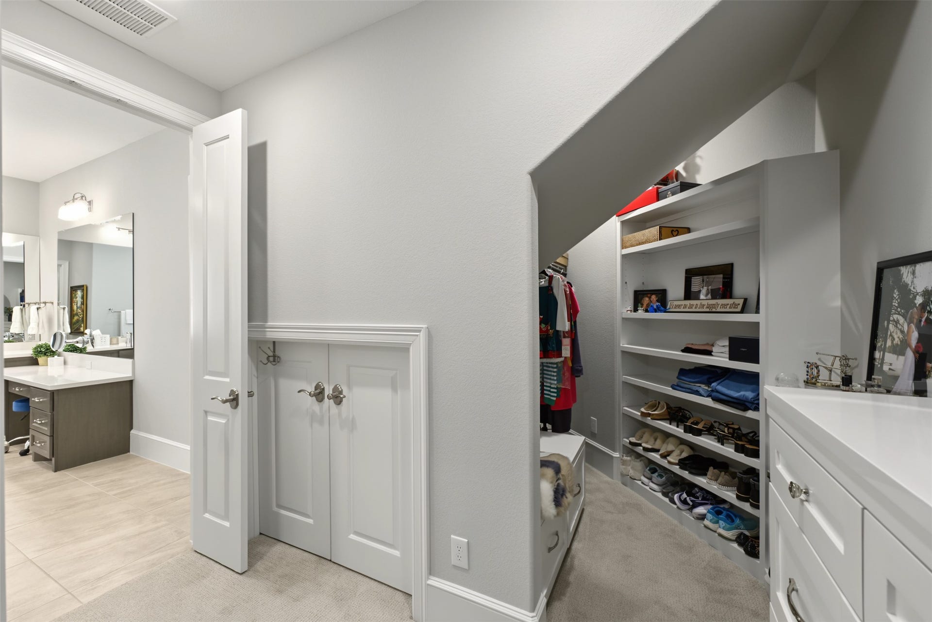 501 Corsair Court, Montgomery, TX 77316 Walk-in primary closet has built-in dresser and custom shelving with bench seat. Also in the primary closet is access to the safe room.