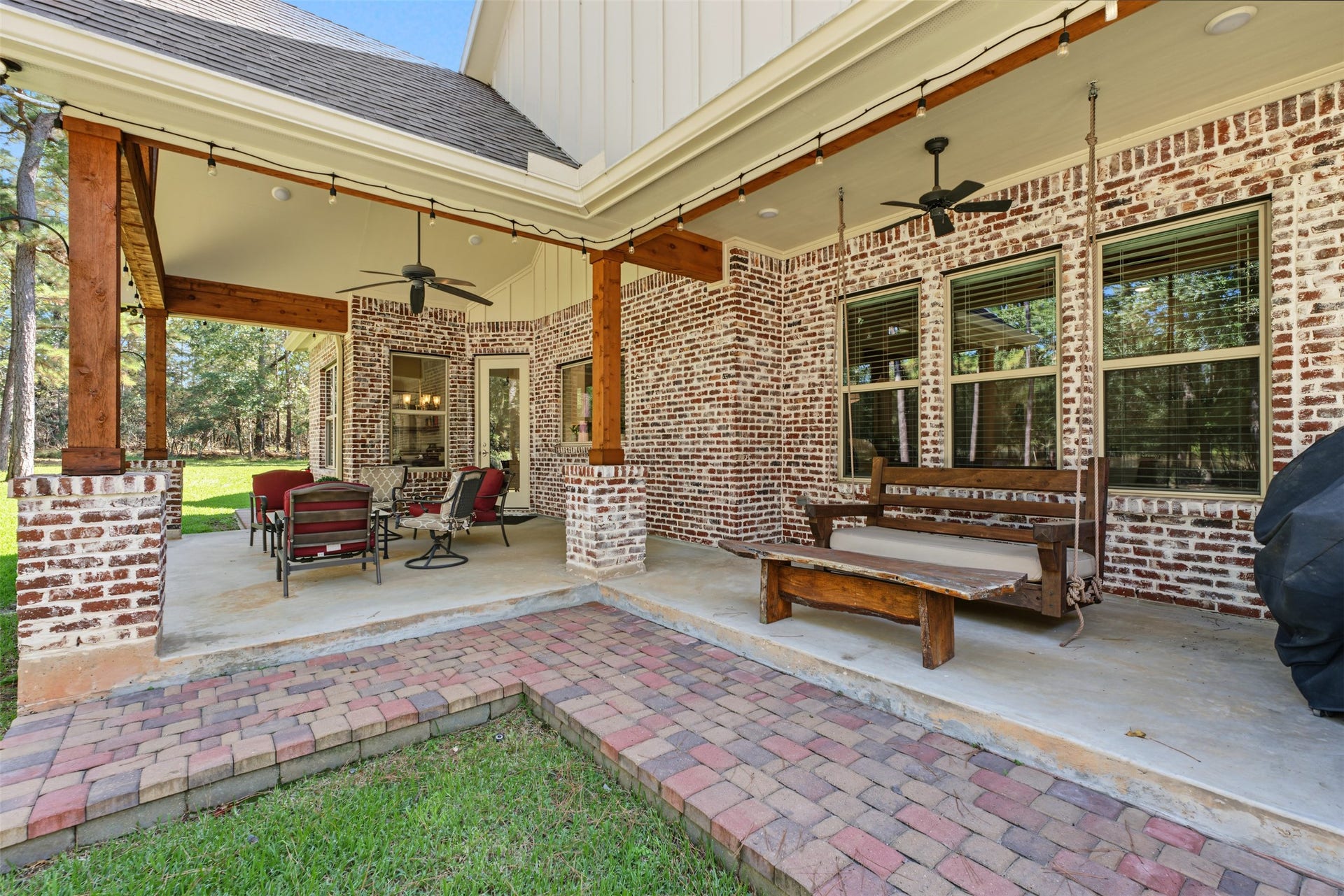 501 Corsair Court, Montgomery, TX 77316 Sit and swing a while on the patio (porch) that wraps around toward the fenced side of the garage.