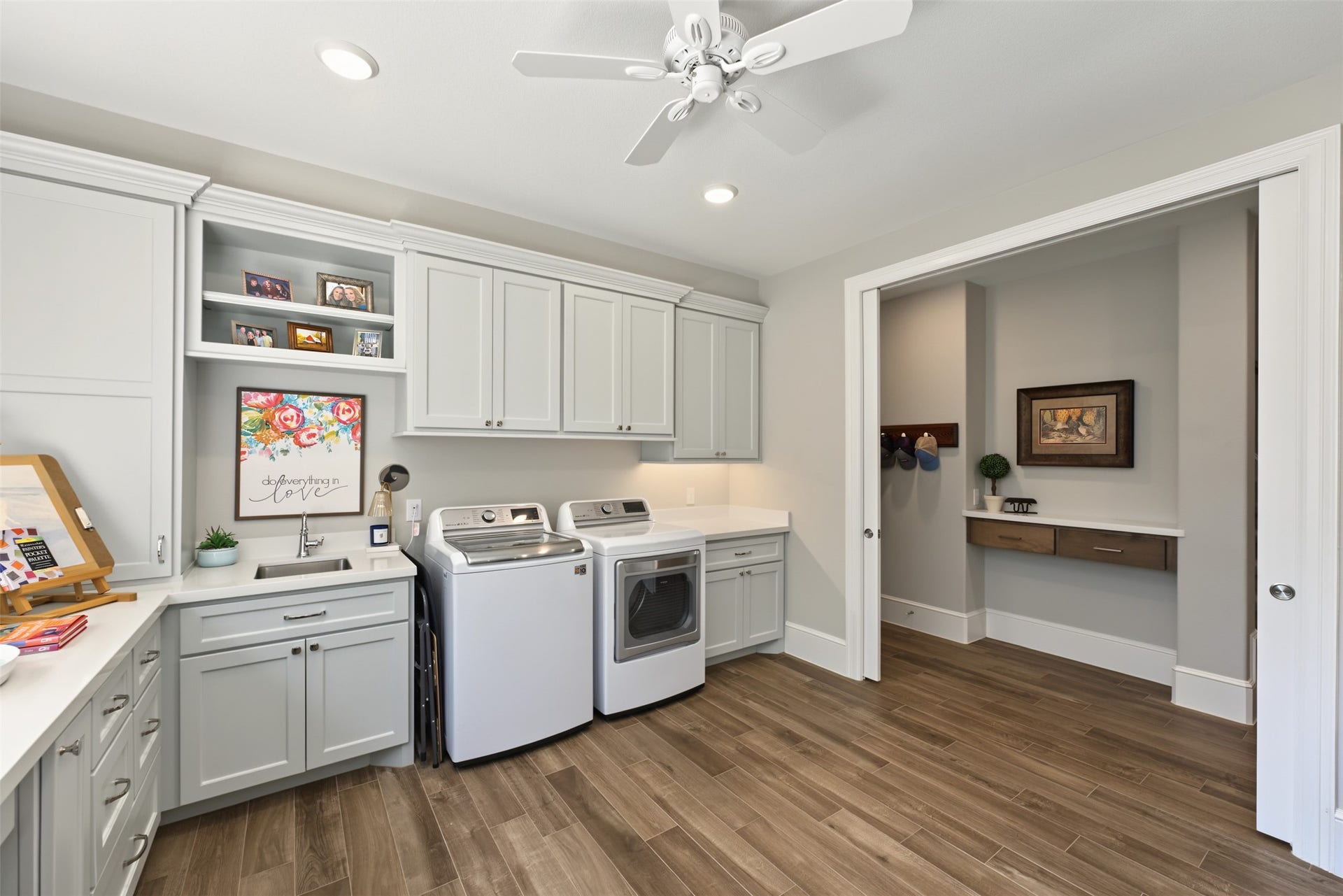 501 Corsair Court, Montgomery, TX 77316 Utility room aptly named. Keep your eye on laundry, deliveries and craft away or manage work and home from this beautiful multipurpose room with many custom cabinet features. Double pocket doors allow for a quiet work space.
