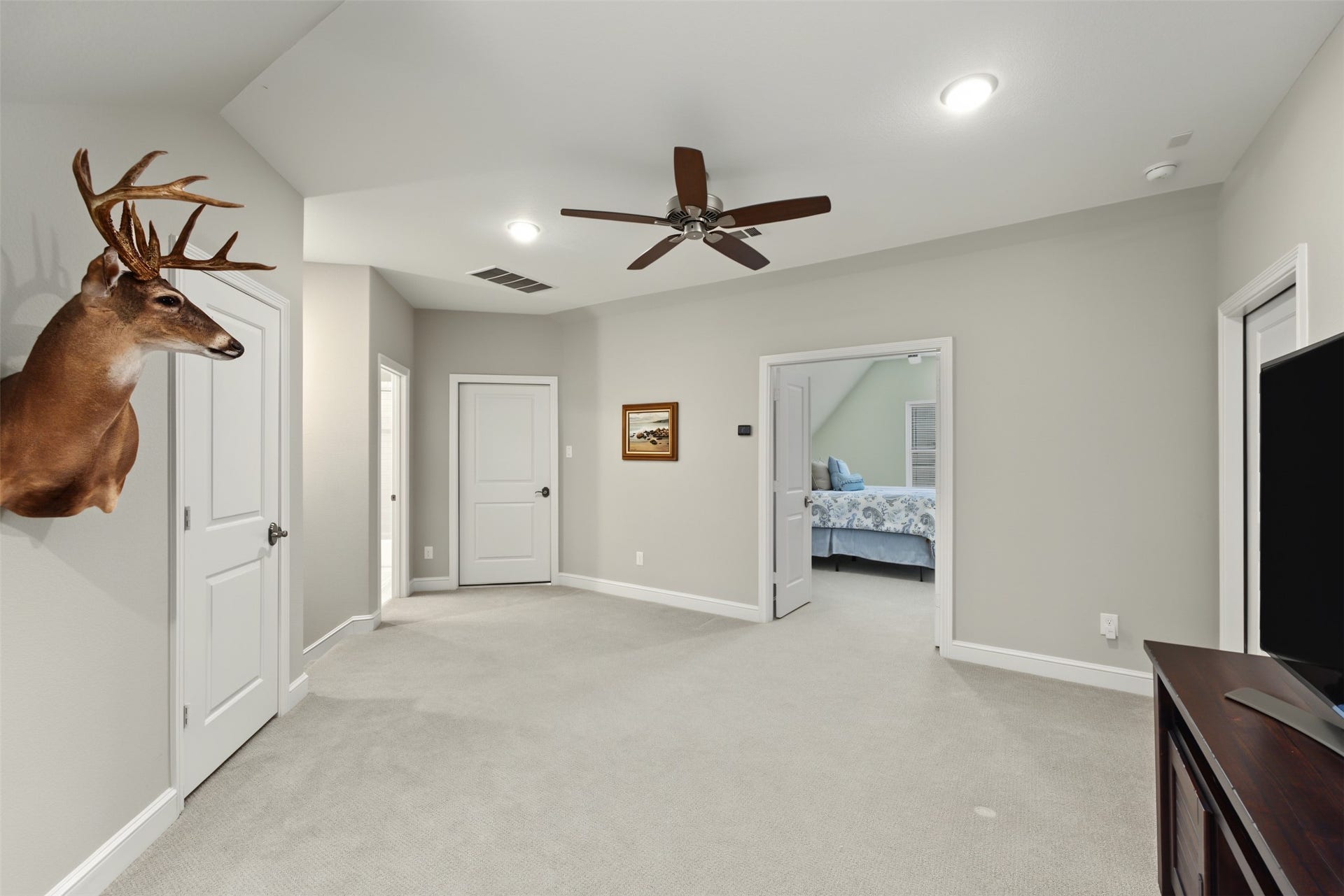 501 Corsair Court, Montgomery, TX 77316 Up the hallway stairs from the utility room is the gameroom or extra living space for the upstairs bedroom.