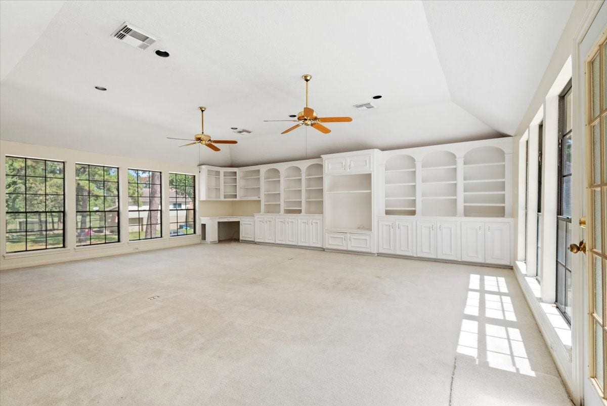 7514 Pinehurst Shadows Drive, Humble, TX 77346 Extra large game room features built-ins, 2 ceiling fans, a raised ceiling, access to the deck and back staircase.