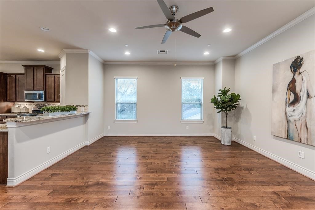 Large open plan Living Room with hard wood floor, ceiling fan, breakfast bar