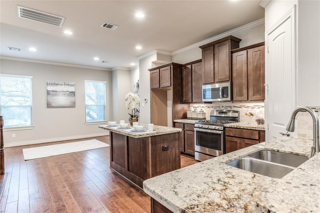 Large Dining area boasts lots of natural lighting & beautiful views of the green space with lush trees