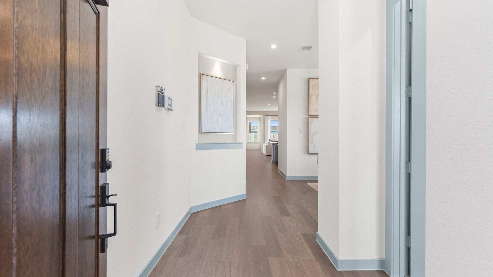 Entry hallway leading to living room and kitchen in the background.