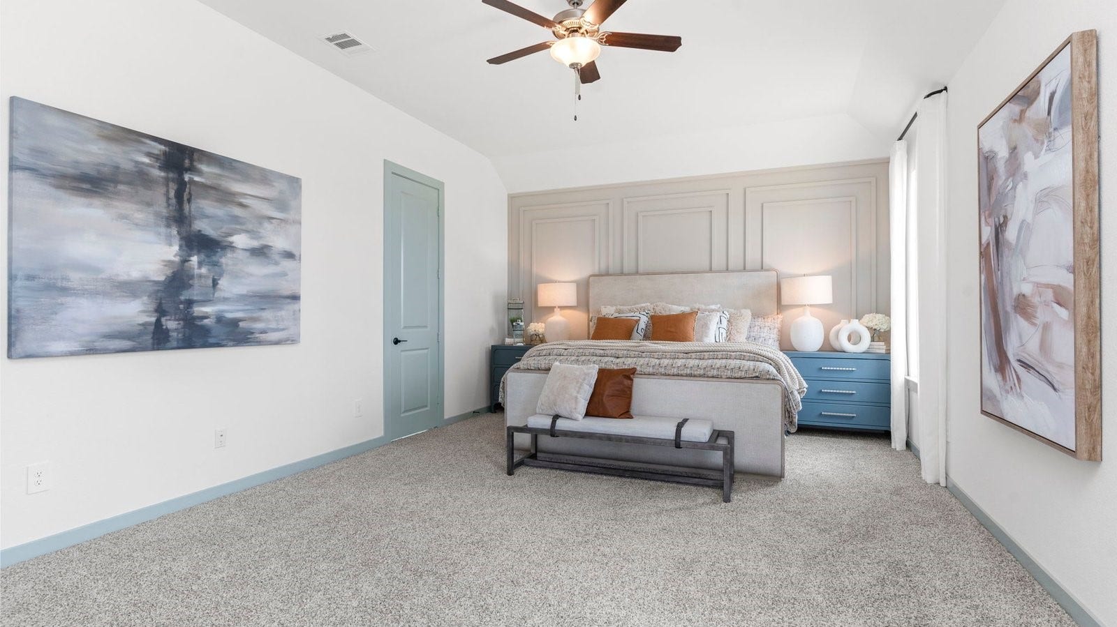 A spacious primary bedroom emphasizing open space and natural lighting with large windows.
