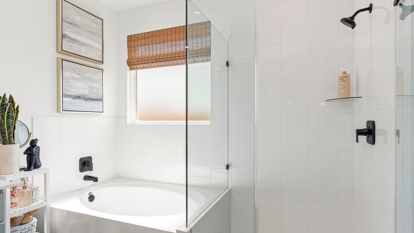 Primary bathroom with a glass-enclosed standing shower and separate soaking tub.