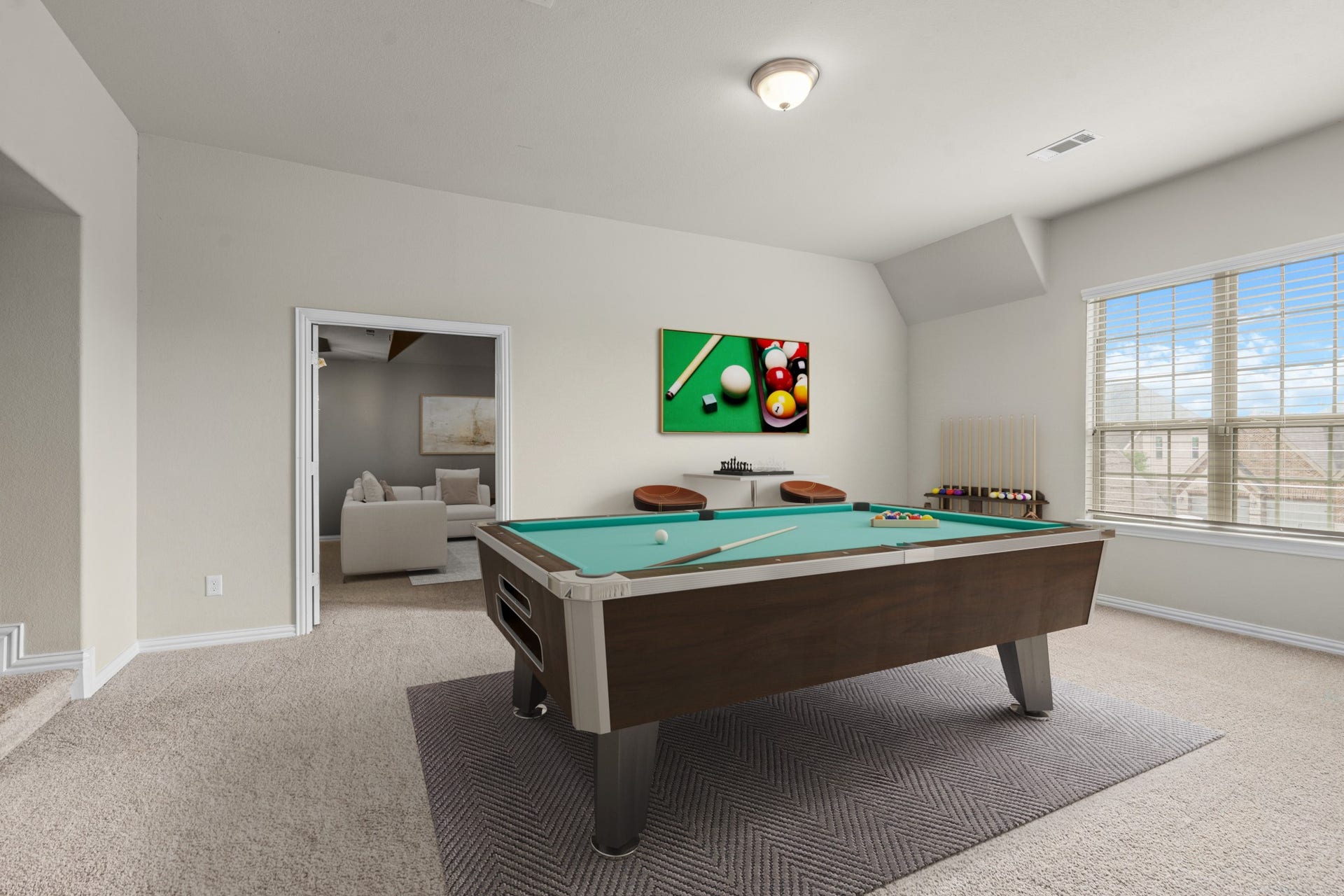 Virtually Staged: A large upstairs game room or flexible bonus space offers a built-in study wrap-desk and double doors that open into the media room.
