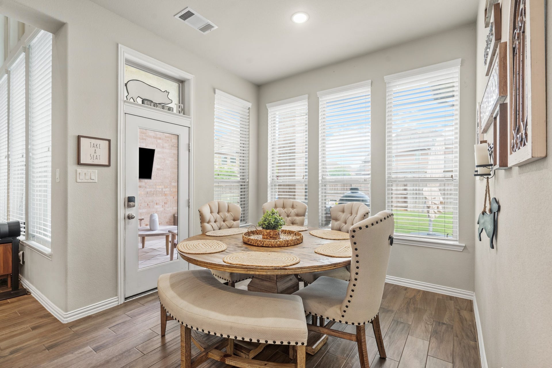 Surrounded by bright backyard views, the breakfast room easily accommodates an oversized table and features a distinct transom window detail above the patio access door.