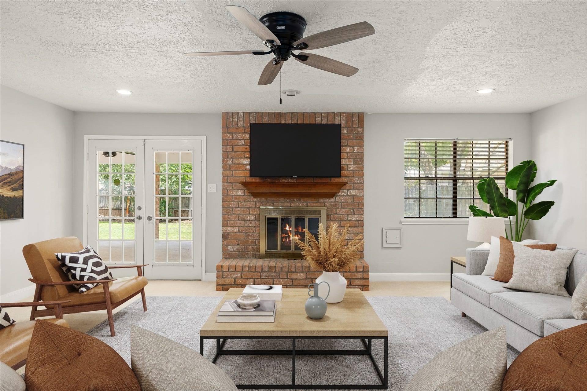 8007 Suspiro Drive, Houston, TX 77083 The focal point of this light-filled family room is a handsome floor-to-ceiling brick fireplace with a custom wood mantel, creating an inviting space for relaxation or entertaining. *Virtually Staged