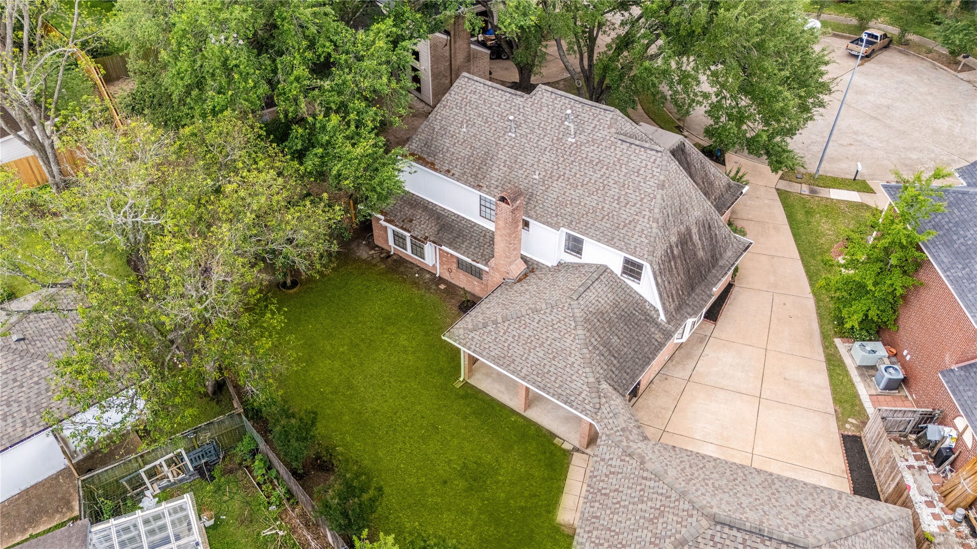8007 Suspiro Drive, Houston, TX 77083 Drone view of the backyard and long driveway to detached 3-car garage.