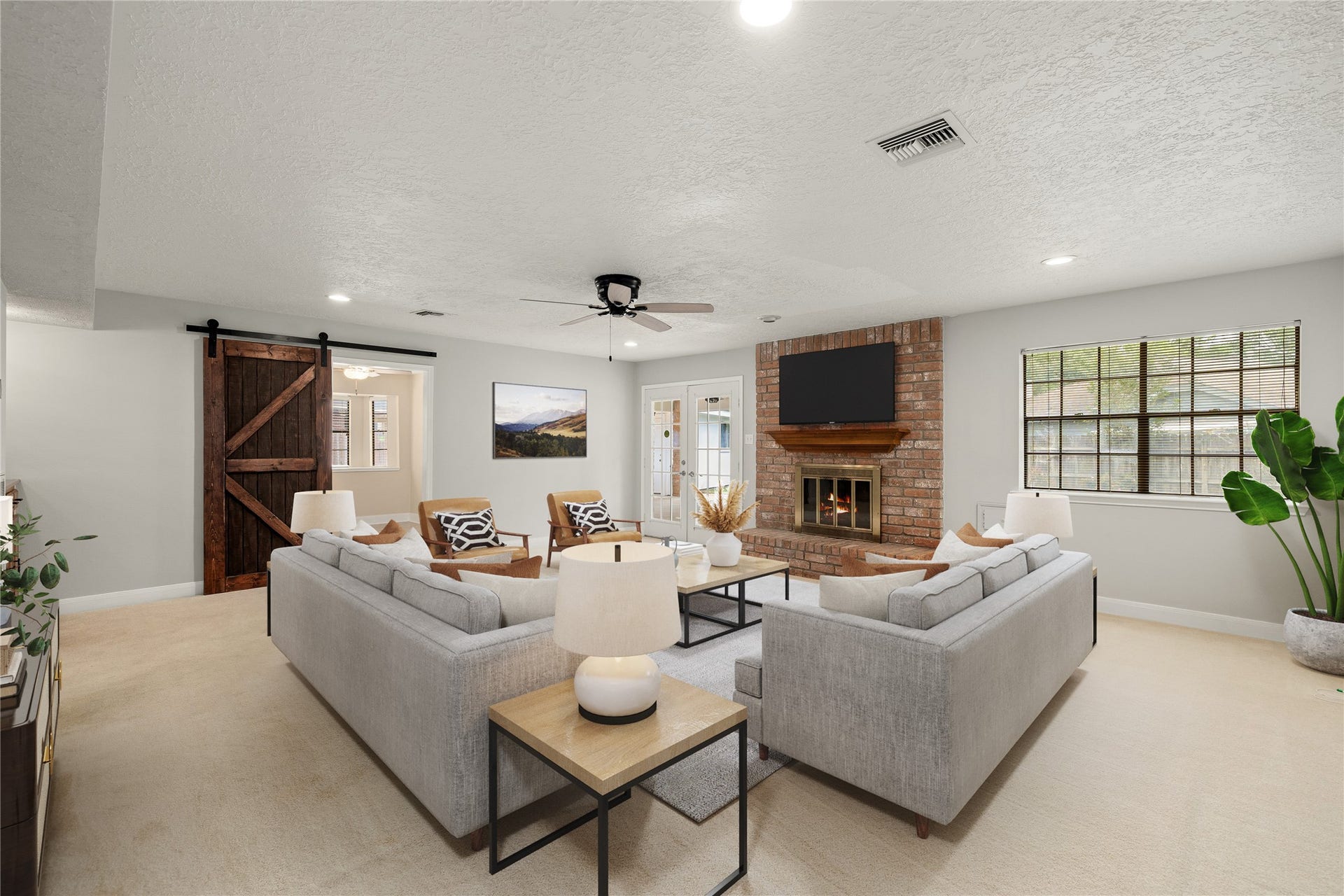 8007 Suspiro Drive, Houston, TX 77083 This expansive living area seamlessly transitions into the heart of the home, featuring a stylish sliding barn door that opens to the kitchen and breakfast nook. *Virtually Staged
