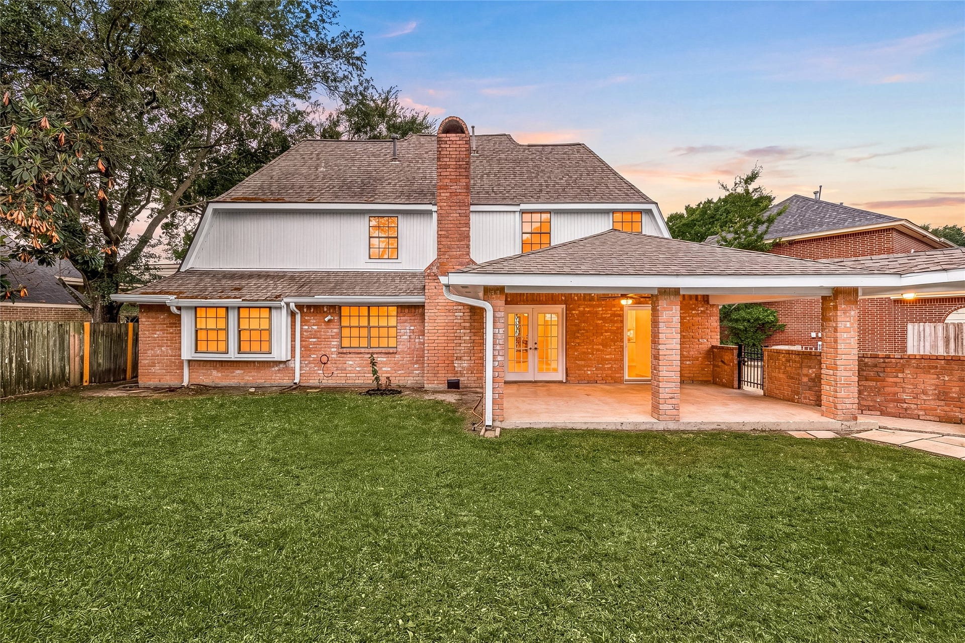 8007 Suspiro Drive, Houston, TX 77083 Step into your own private backyard oasis! This expansive, lush green lawn is perfect for play, gardening, or future poolside dreams. The classic brick exterior is accented by large windows that flood the home with natural light and overlook the peaceful outdoor space. Featuring mature trees for shade and a covered patio area, this backyard is the ultimate setting for summer BBQs and quiet evenings under the stars.