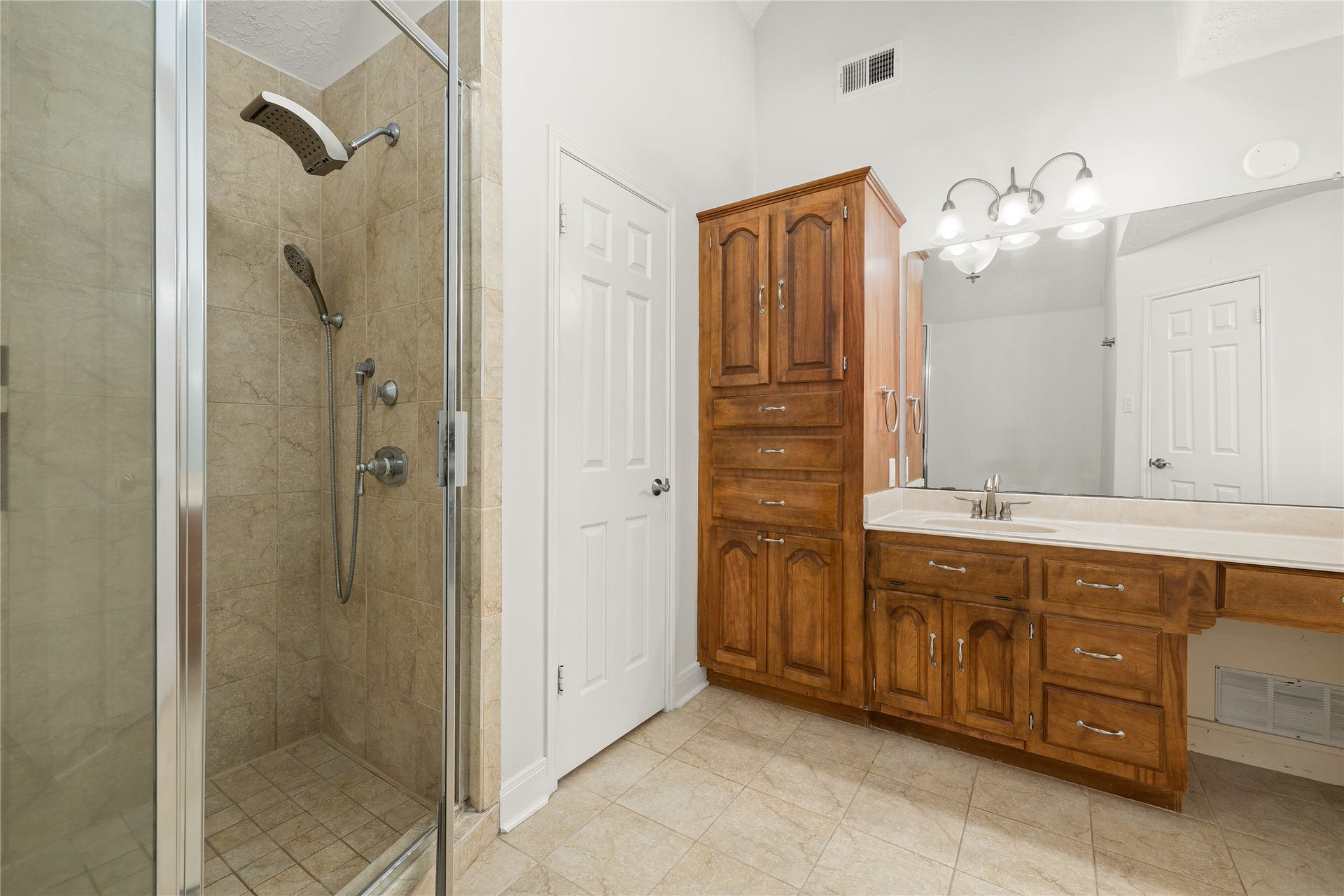 8007 Suspiro Drive, Houston, TX 77083 Indulge in a spa-like experience with this meticulously designed walk-in shower, a standout feature of the primary ensuite. Combining modern luxury with practical elegance, this space offers a tranquil retreat for your daily routine.