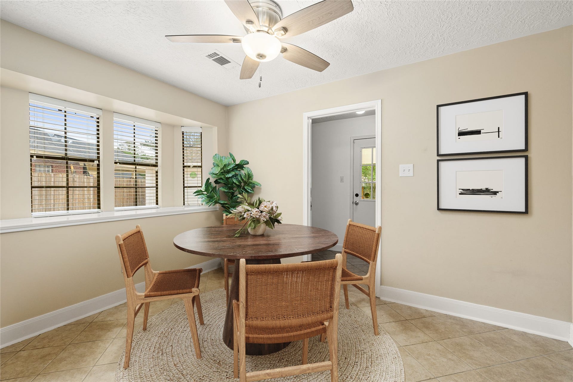 8007 Suspiro Drive, Houston, TX 77083 Start your mornings in this sun-drenched breakfast nook, where a charming bay window offers peaceful views of the outdoors. This intimate dining space is perfectly positioned for casual meals and morning coffee, blending comfort with a bright, airy aesthetic. *Virtually Staged