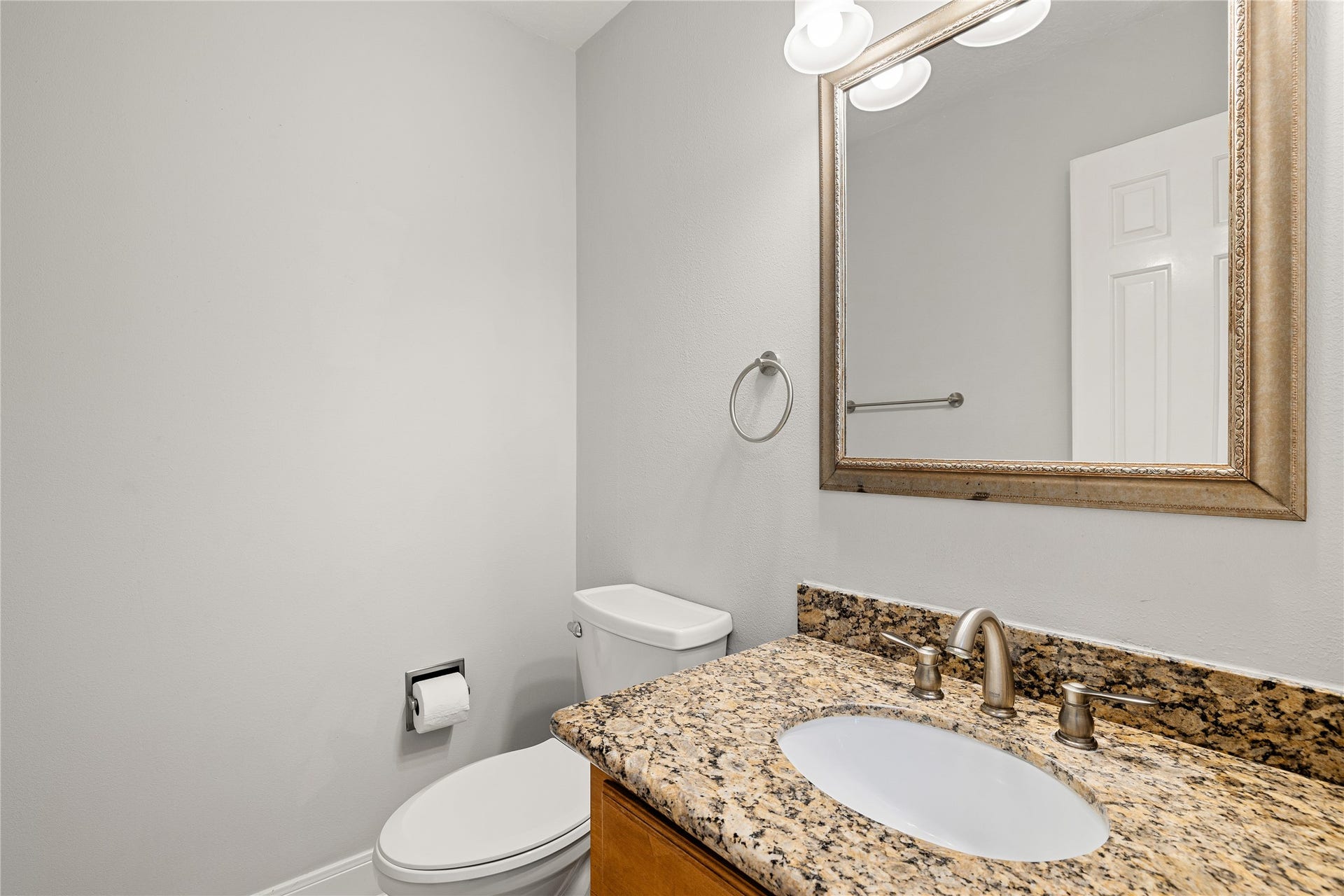 8007 Suspiro Drive, Houston, TX 77083 Tucked away for privacy but conveniently located near the main living areas, this thoughtfully updated powder room features granite countertop vanity, framed mirror and sleek modern finishes.