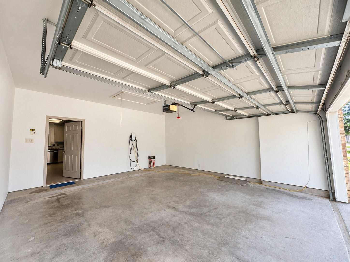 2027 Marchwood Manor Drive, Houston, TX 77090 Garage with a Tesla charger.