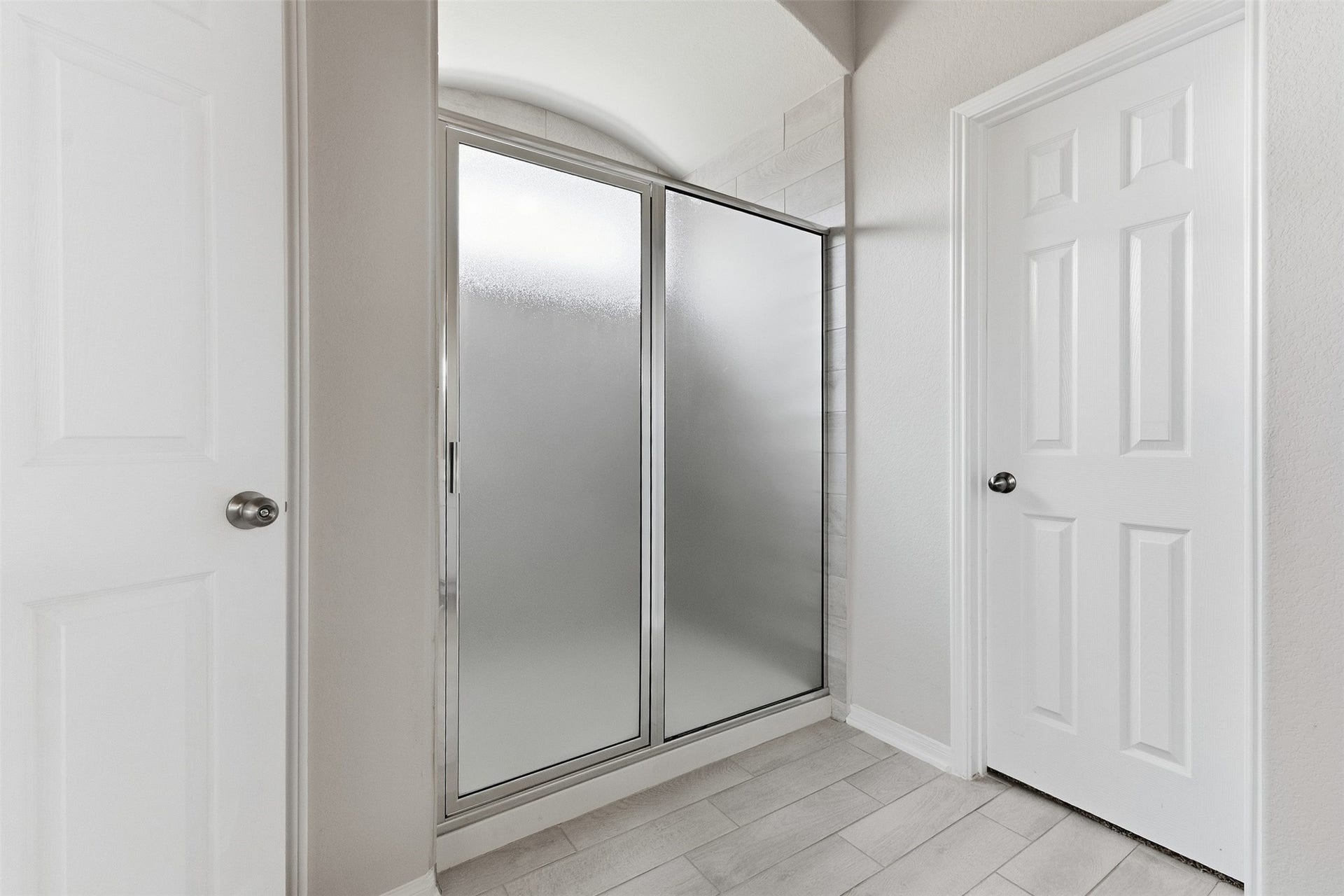 A separate tub and shower accompany the primary bathroom along with a large walk-in closet.