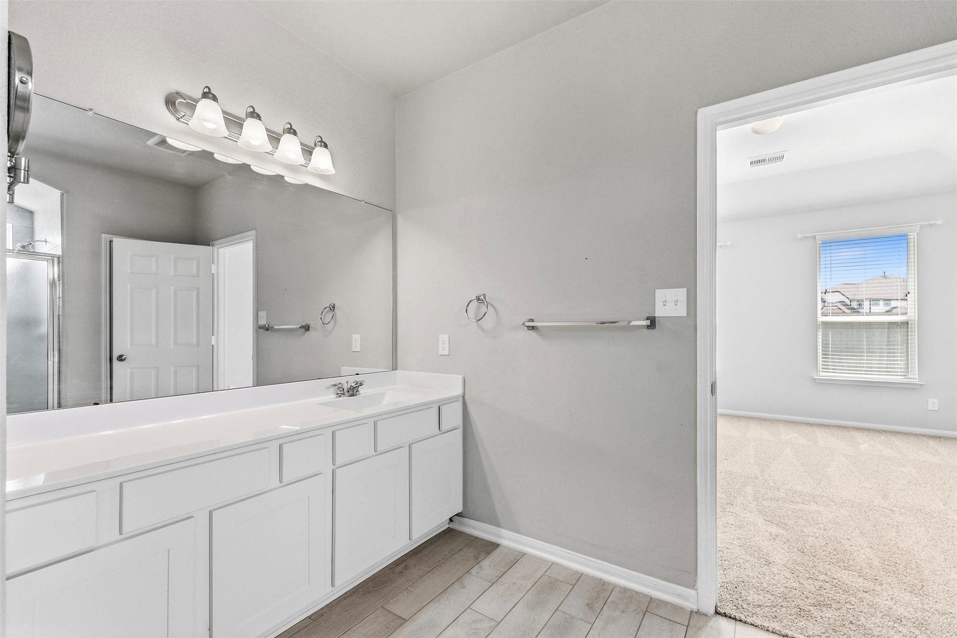 This shared bathroom has a large vanity with plenty of space for the kids to spread out.