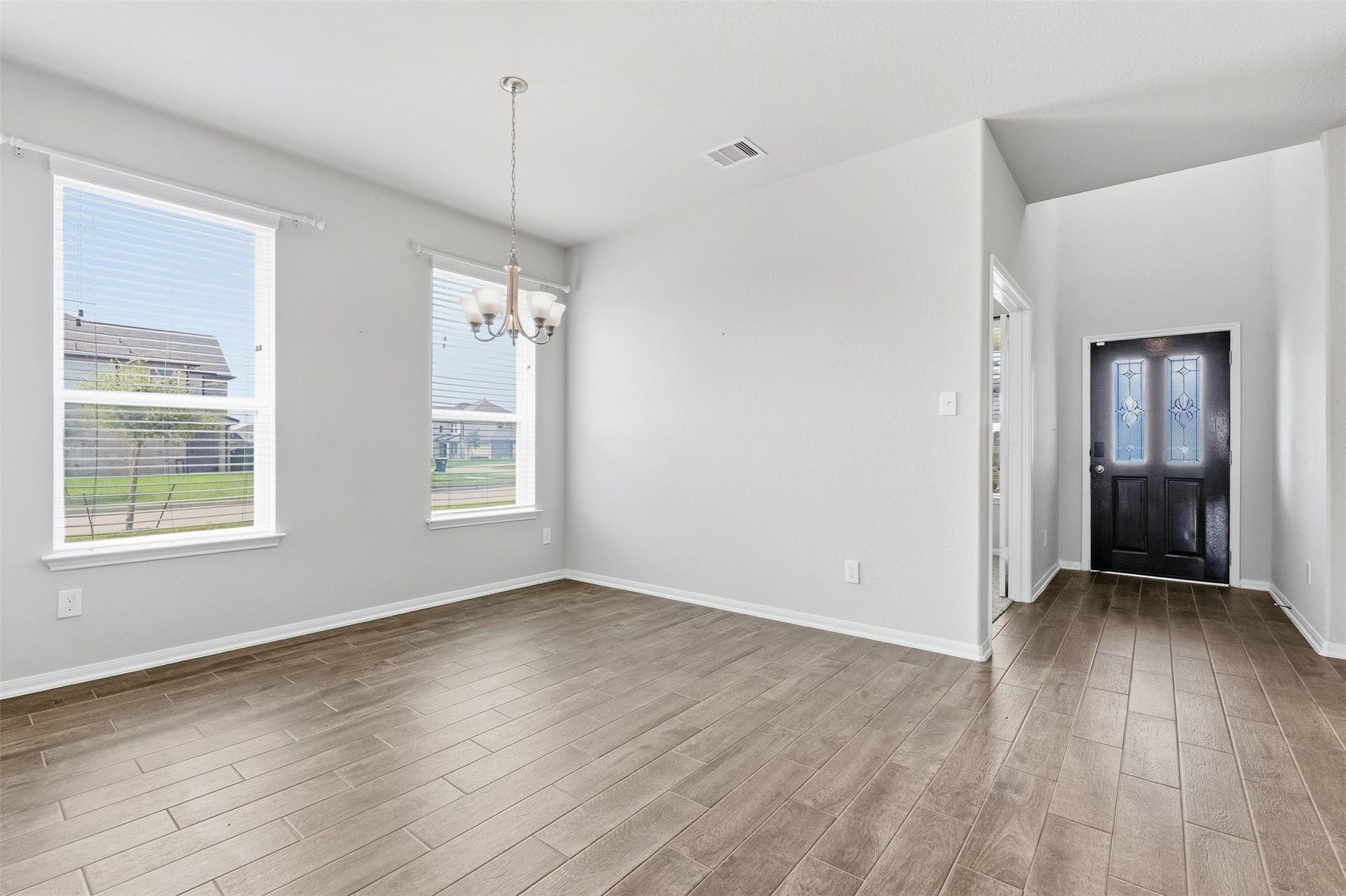 Upon entering, you are greeted by a versatile home office and a formal dining room.