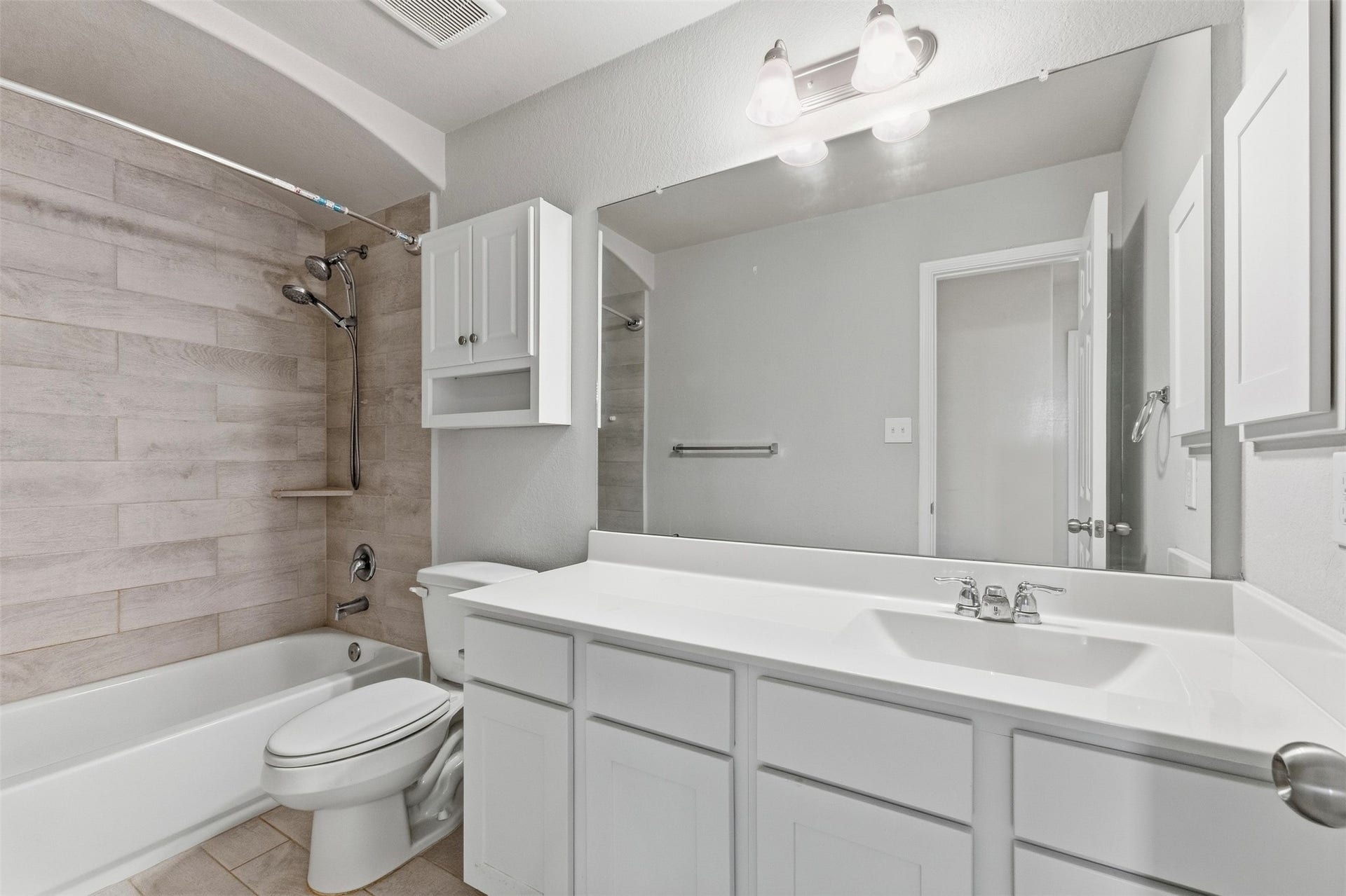 This stunning bathroom features beautiful tile and a crisp, neutral color palette, providing the perfect blank canvas for your creative vision.