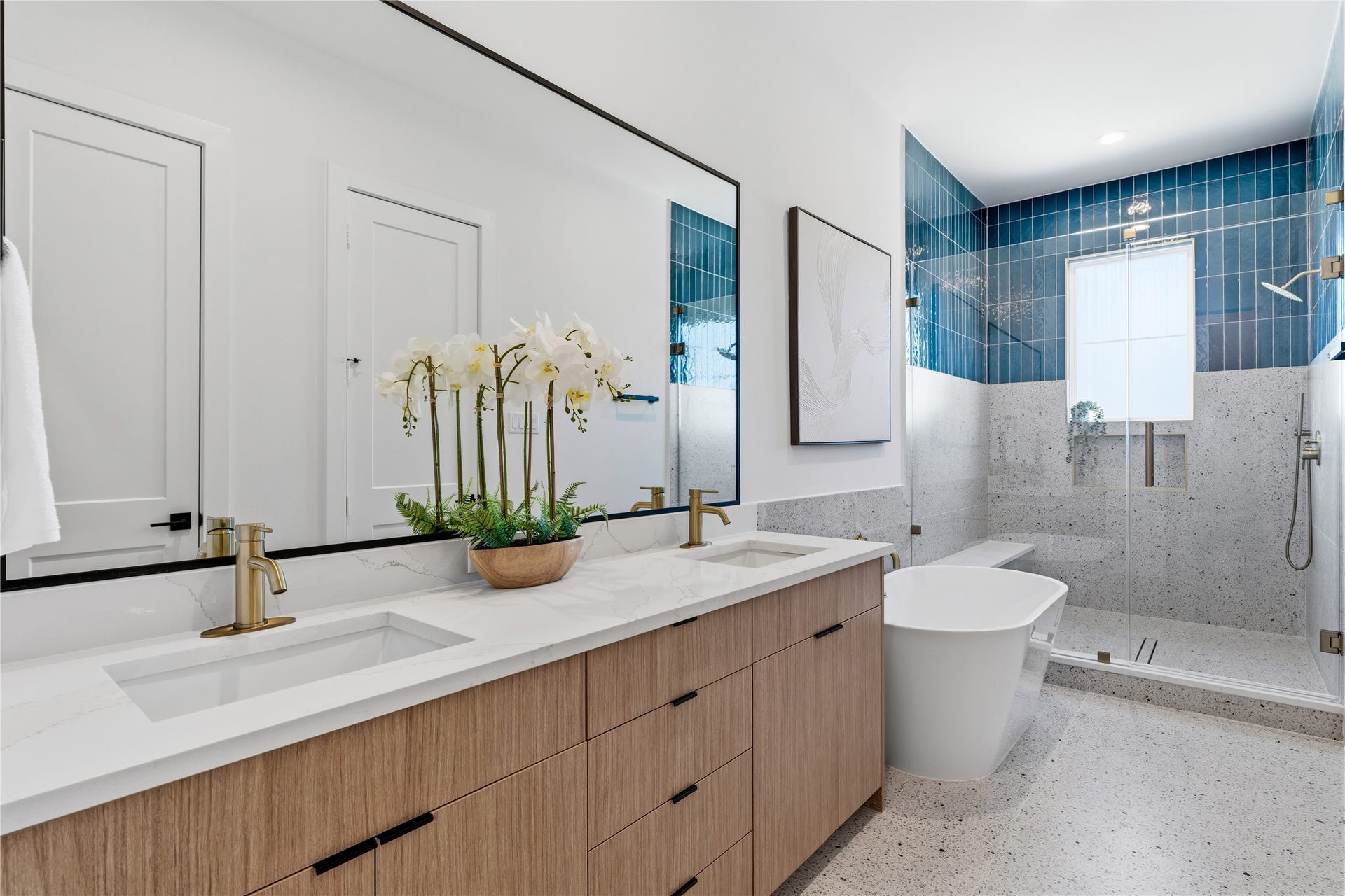 4610 Gunter Street, Houston, TX 77020 Spa-like primary bathroom with dual vanities, freestanding tub, and walk-in glass shower.