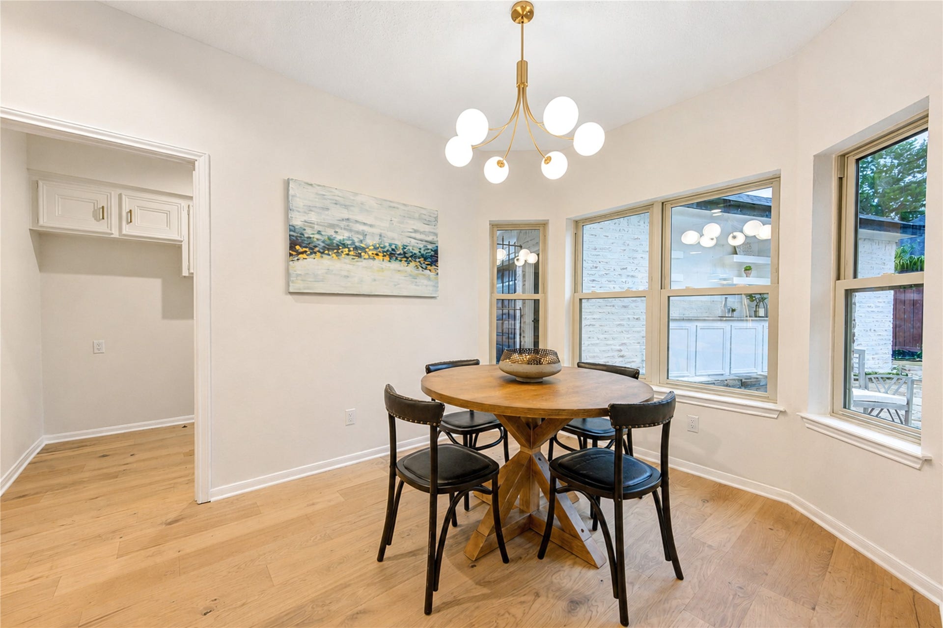 Light-filled breakfast room overlooks the backyard, creating a cheerful setting for morning coffee, casual meals and lingering weekend breakfasts. Expansive windows bring the outdoors in while keeping this everyday gathering space bright and inviting.