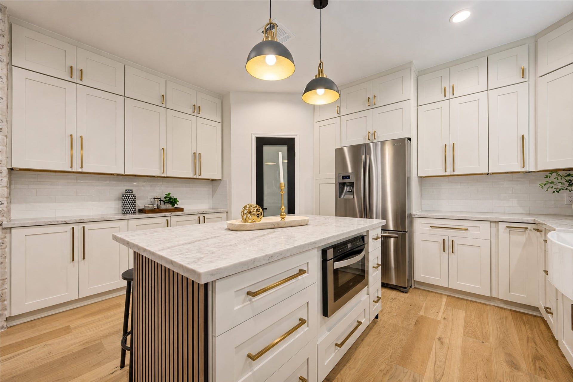 Completely redesigned kitchen showcases all-new Shaker-style cabinetry, beautiful quartzite countertops and a large center island offering generous prep space, storage and seatingperfect for everything from morning coffee and casual meals to entertaining friends.