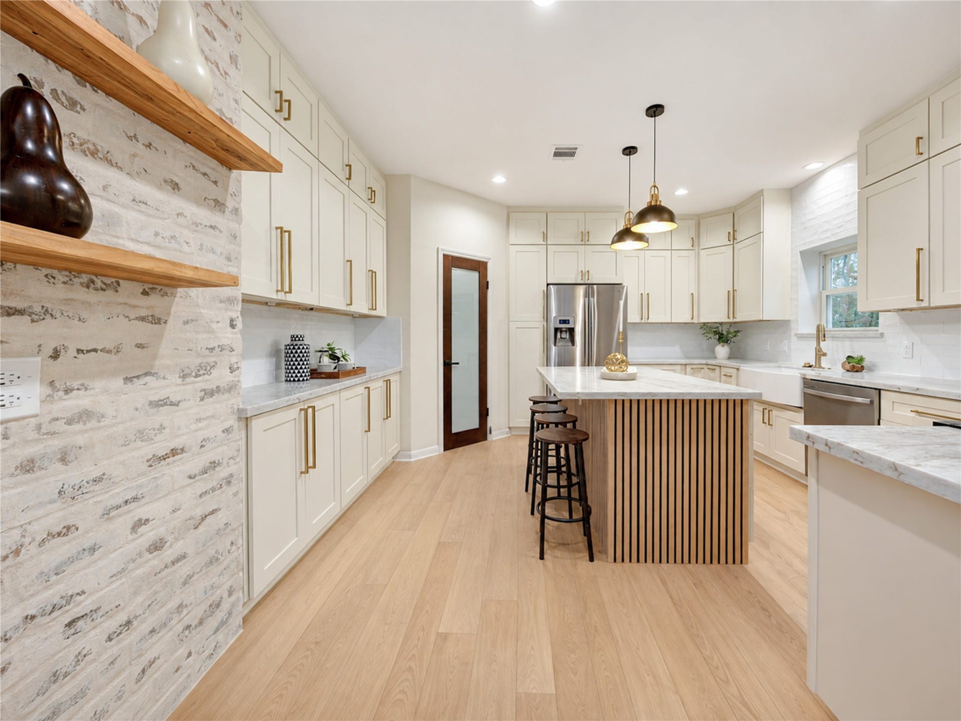 Another view of the beautifully redesigned kitchen highlights its thoughtful layout, generous gathering island and abundant storagean inviting space where morning coffee, weeknight dinners and conversation with friends naturally come together.