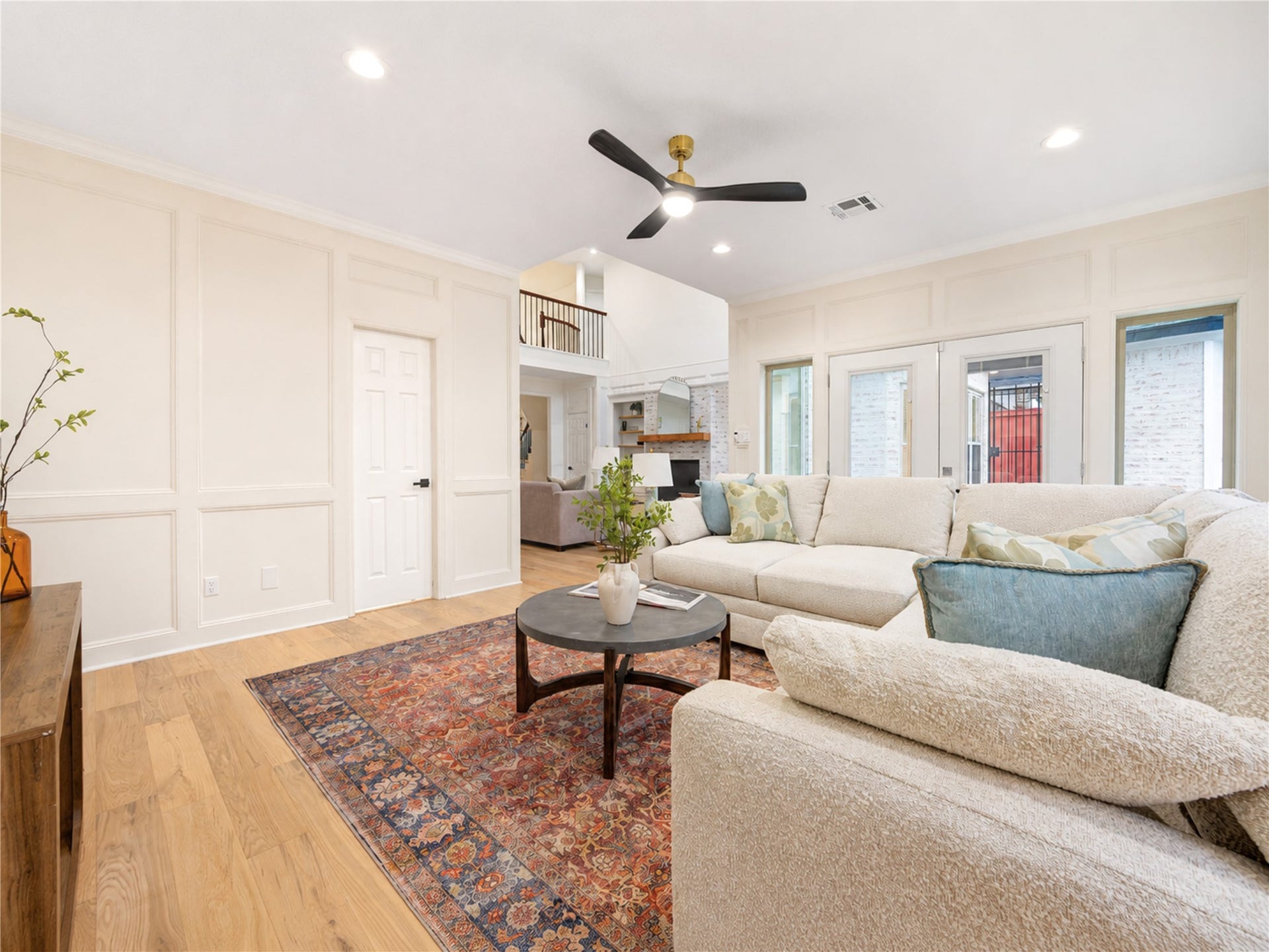 Another view of the spacious den highlights its relaxed, comfortable layoutan ideal spot for casual everyday living, family movie nights, game days or simply unwinding together, with French Oak floors and easy flow to the surrounding living spaces.