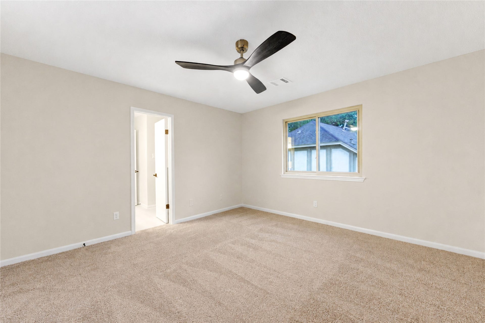 Second upstairs bedroom offers a fresh, comfortable retreat with new carpet, fresh paint and a new ceiling fan. Generous proportions and natural light create a versatile space for family, overnight guests or a quiet study area, with plenty of room to make it their own.