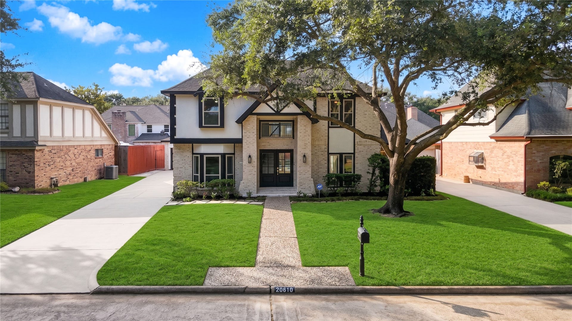 Beautifully updated two-story home in Nottingham Country featuring German schmear brick, striking contrasting architectural accents, mature shade trees, a manicured front lawn and an inviting double-door entry.