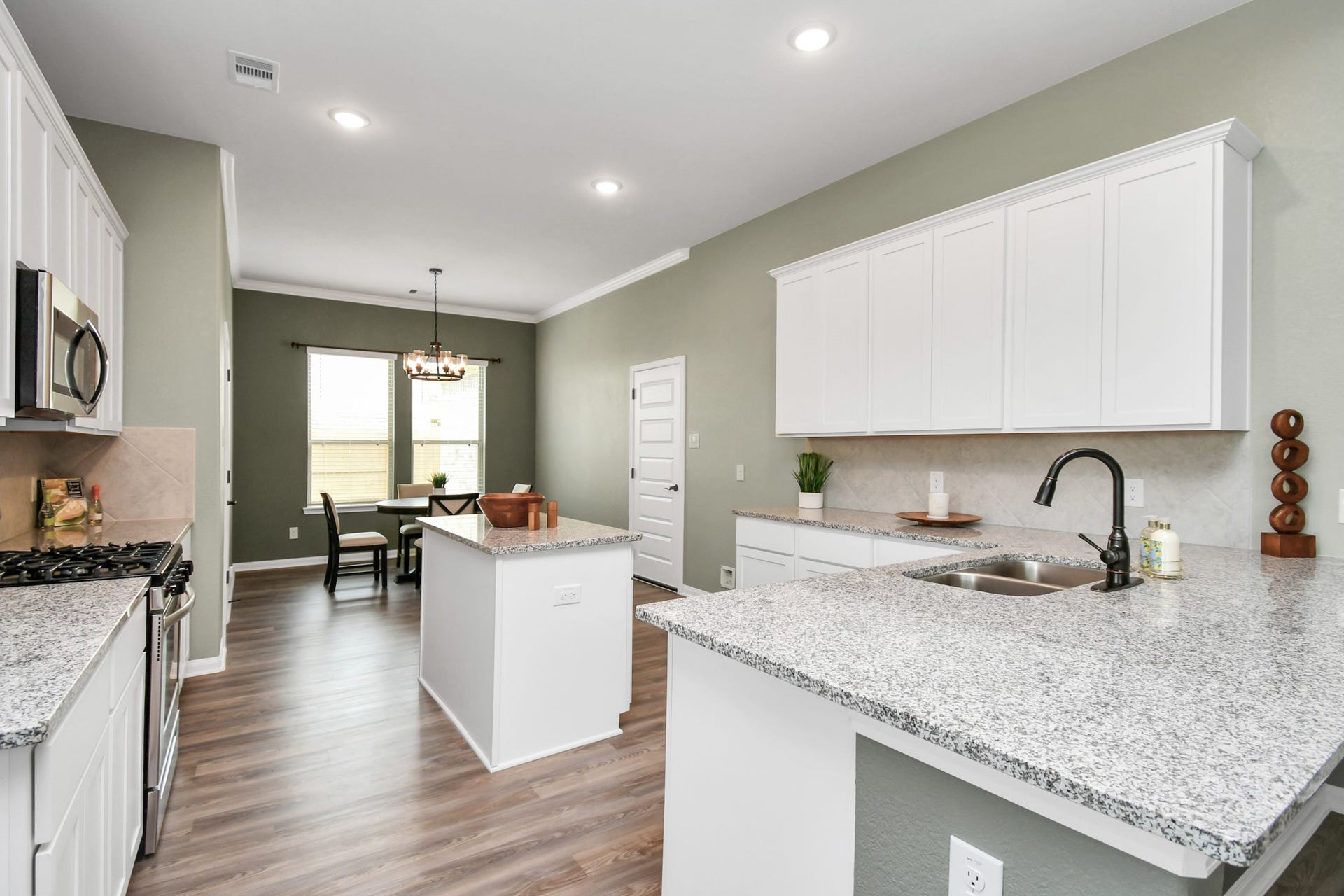 395 Hunter Ranch Way, Dayton, TX 77535 Open kitchen with island, generous cabinetry and views into the main living area