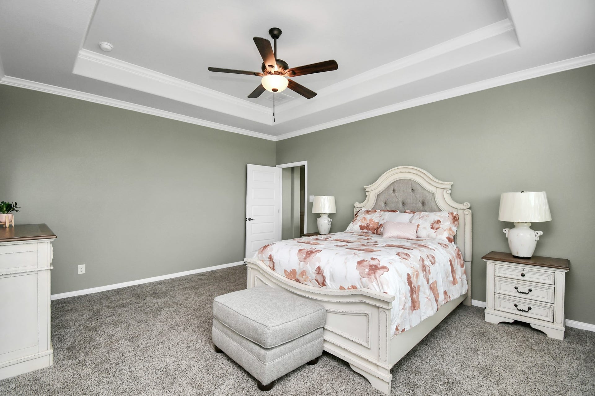 395 Hunter Ranch Way, Dayton, TX 77535 Primary bedroom with tray ceiling, natural light and plenty of room for a complete bedroom suite