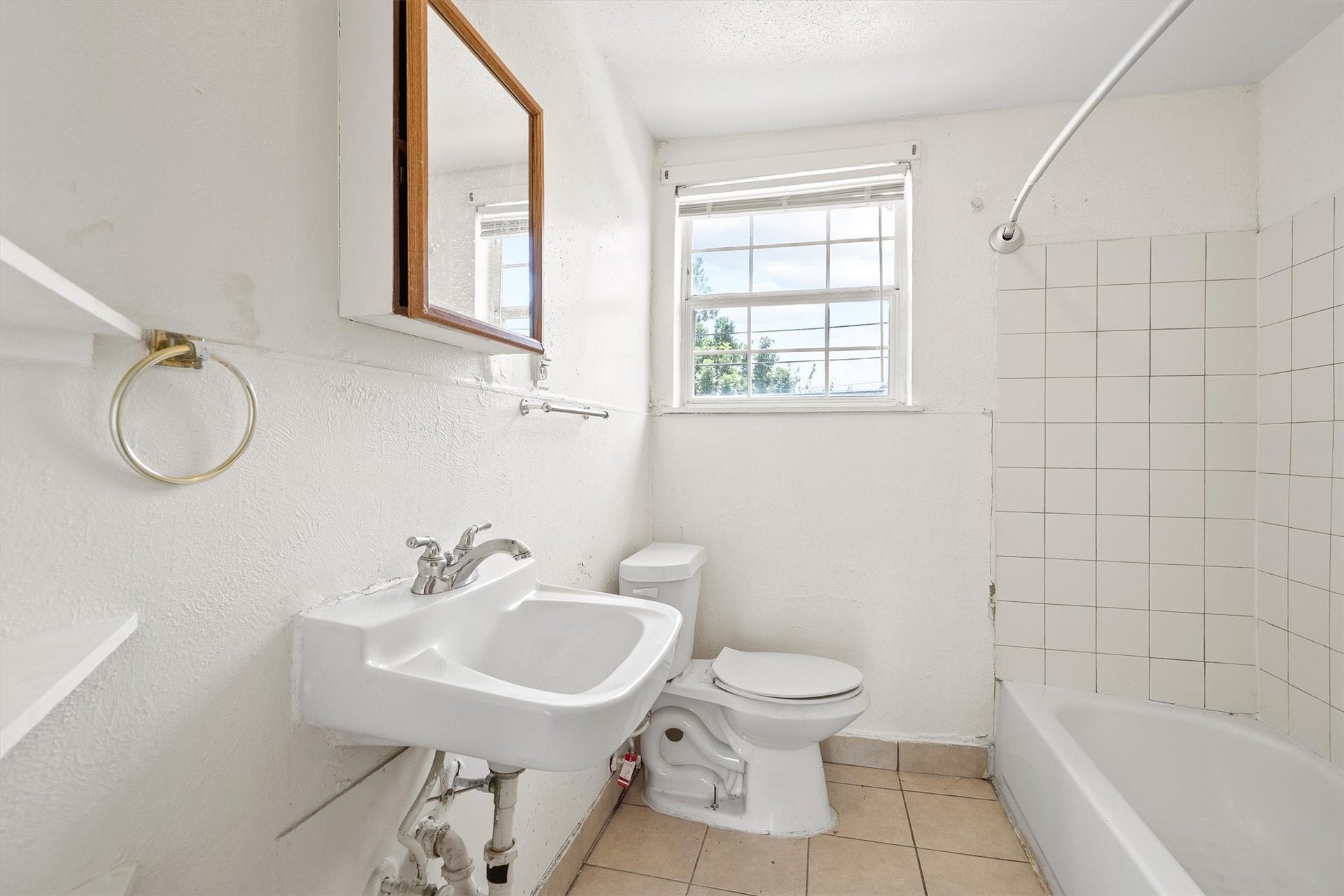 4233 Dupont Street, Houston, TX 77021 This bathroom features a pedestal sink, a toilet, and a shower/tub combo, offering a clean, functional design with everyday comfort in mind.