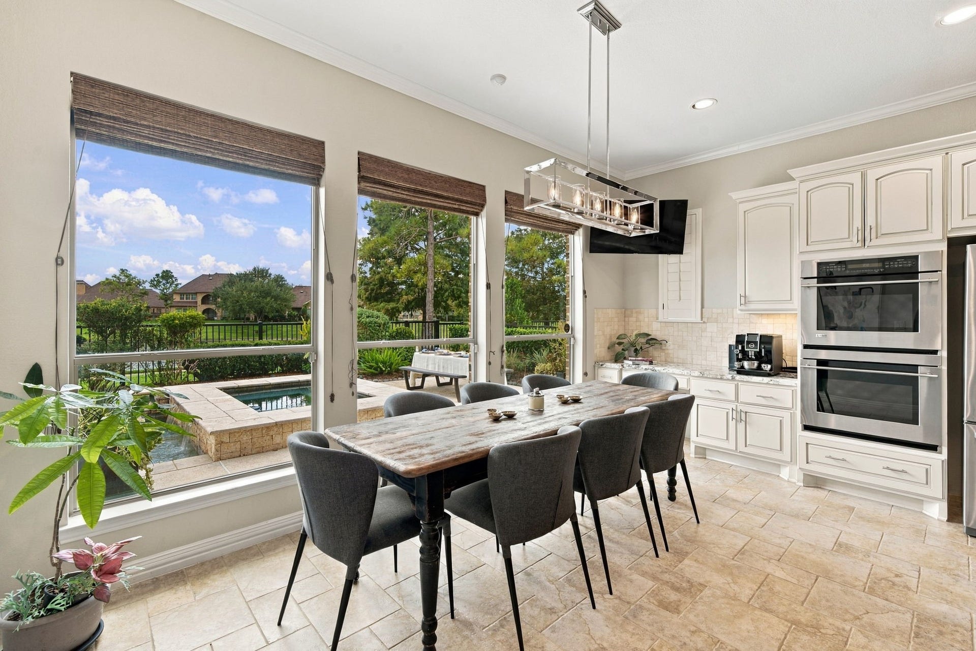 14423 Tivoli Drive, Houston, TX 77077 Oversized windows frame pool and lake views from the casual breakfast area, which sits conveniently alongside the kitchen.