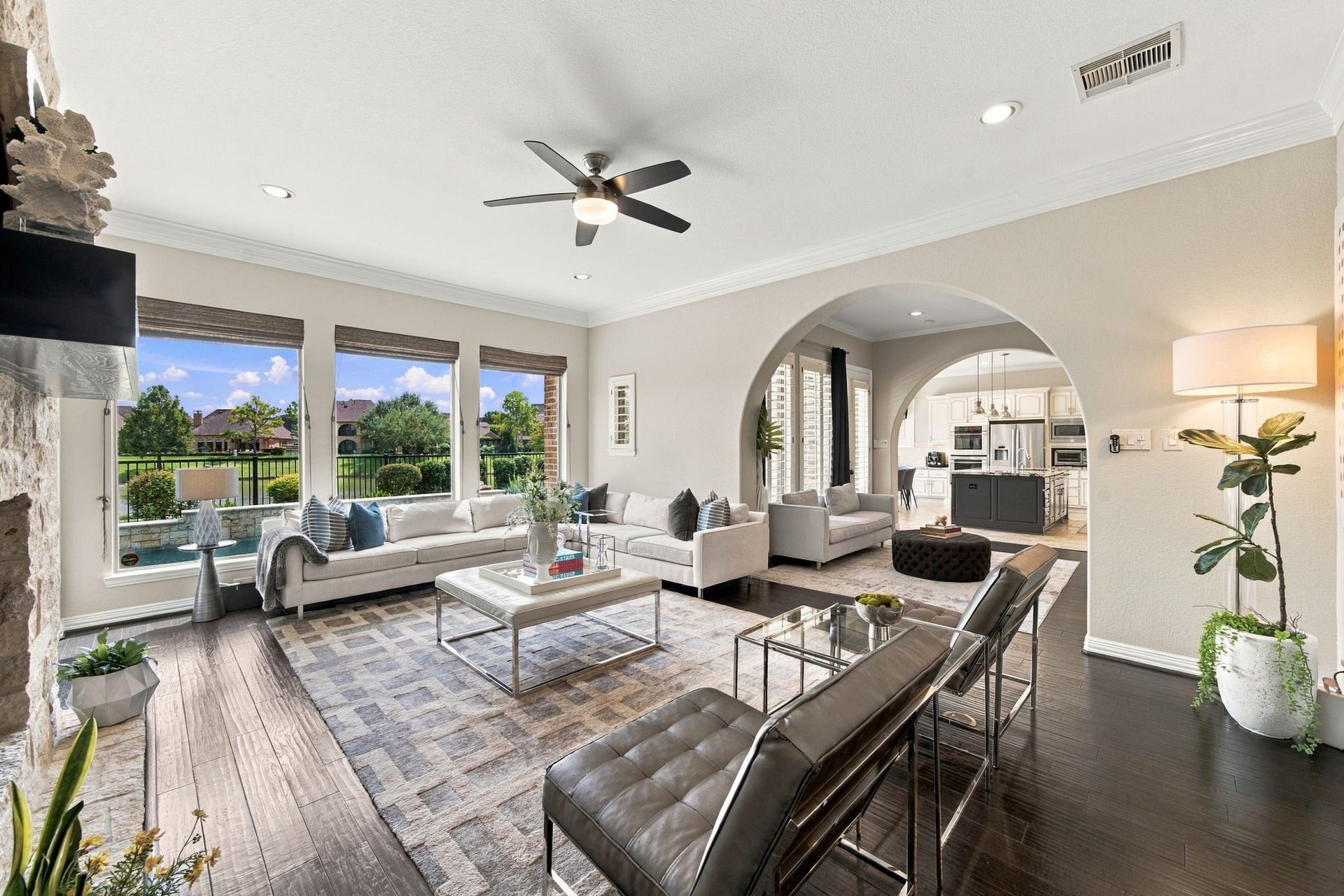 14423 Tivoli Drive, Houston, TX 77077 The spacious living area combines multiple seating zones, abundant natural light and views of the pool and lake beyond.