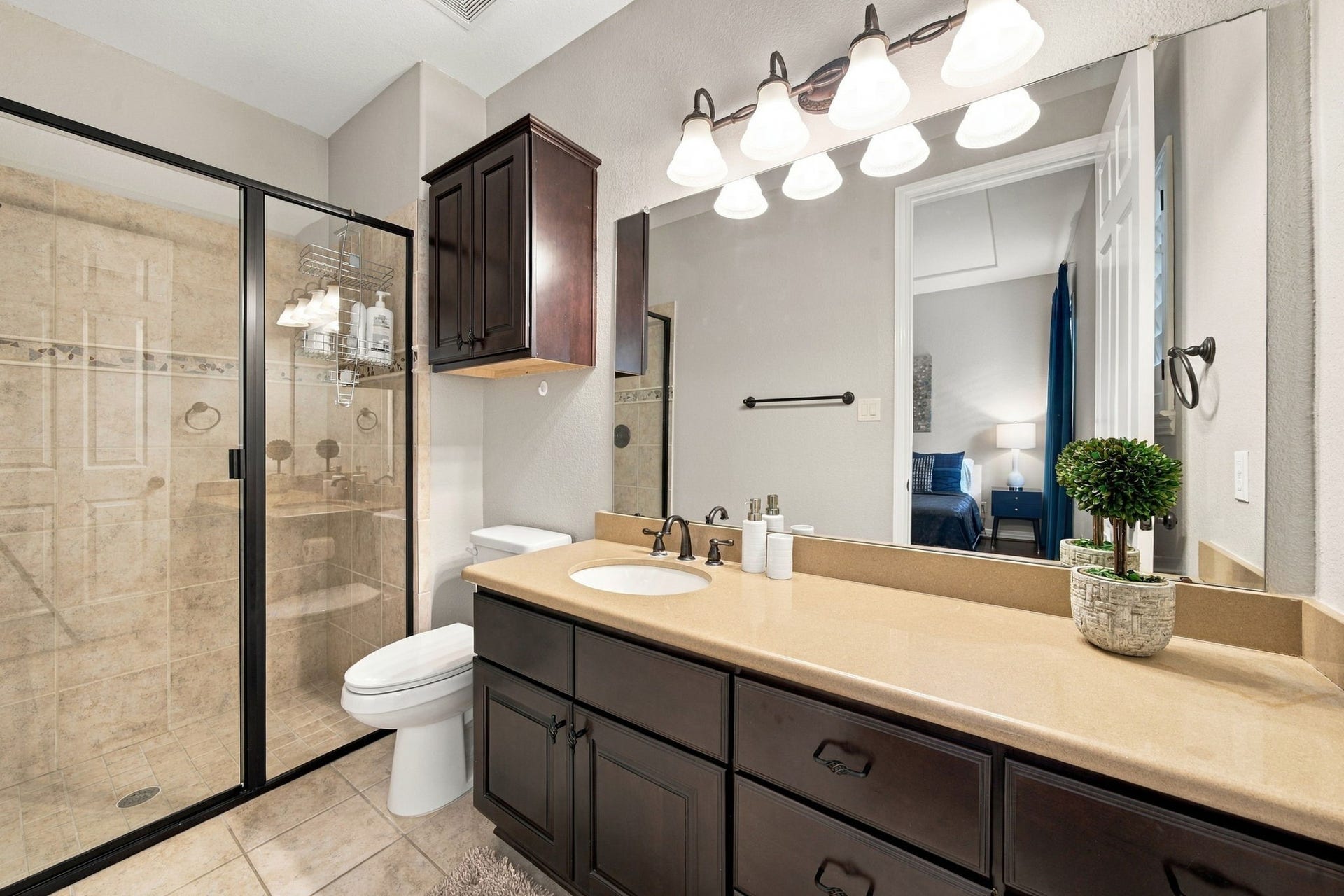 14423 Tivoli Drive, Houston, TX 77077 The en-suite bathroom includes an extended vanity, ample storage and a glass-enclosed standing shower.