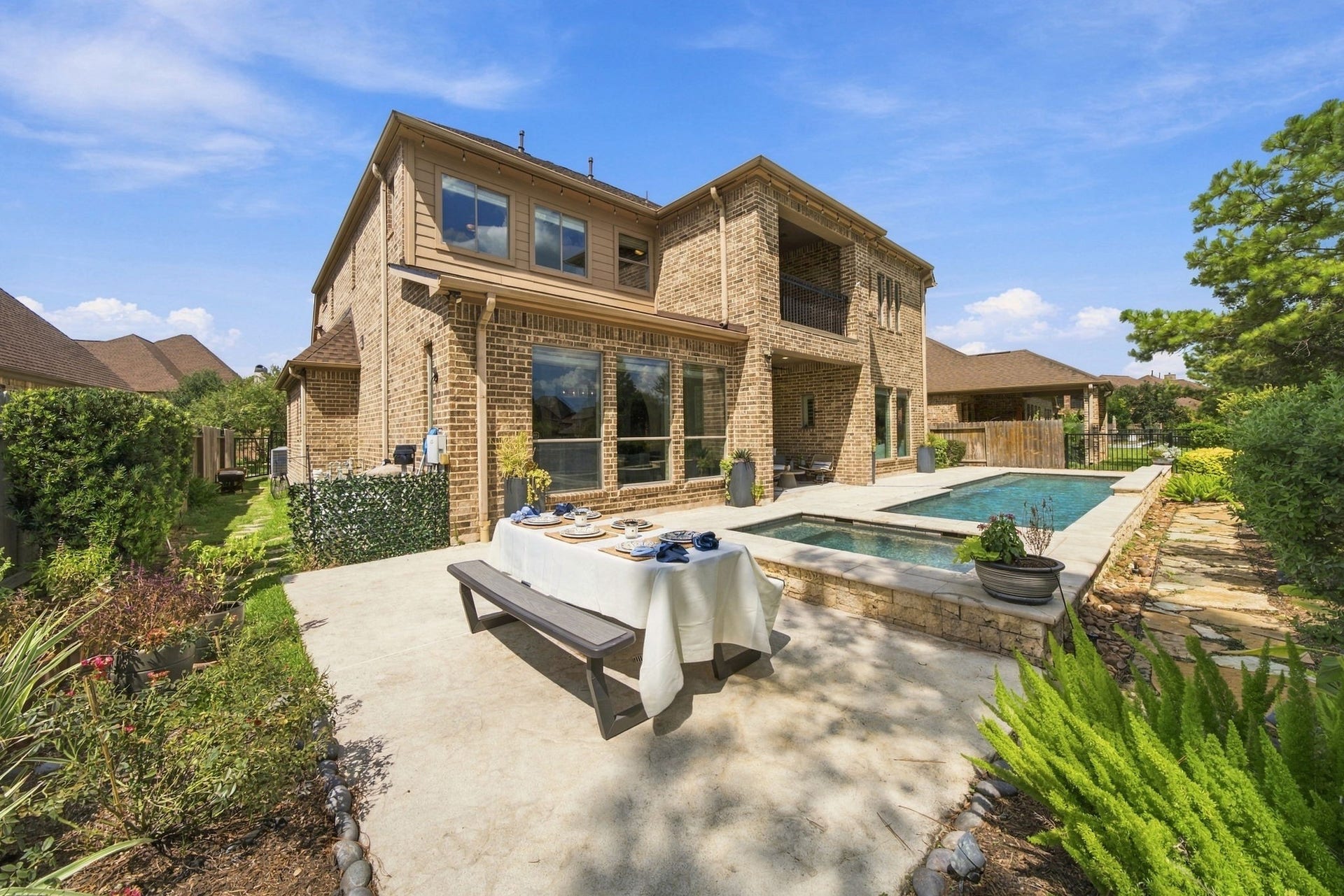 14423 Tivoli Drive, Houston, TX 77077 The landscaped backyard offers a pool and spa, generous patio space and multiple areas for outdoor dining and relaxation.