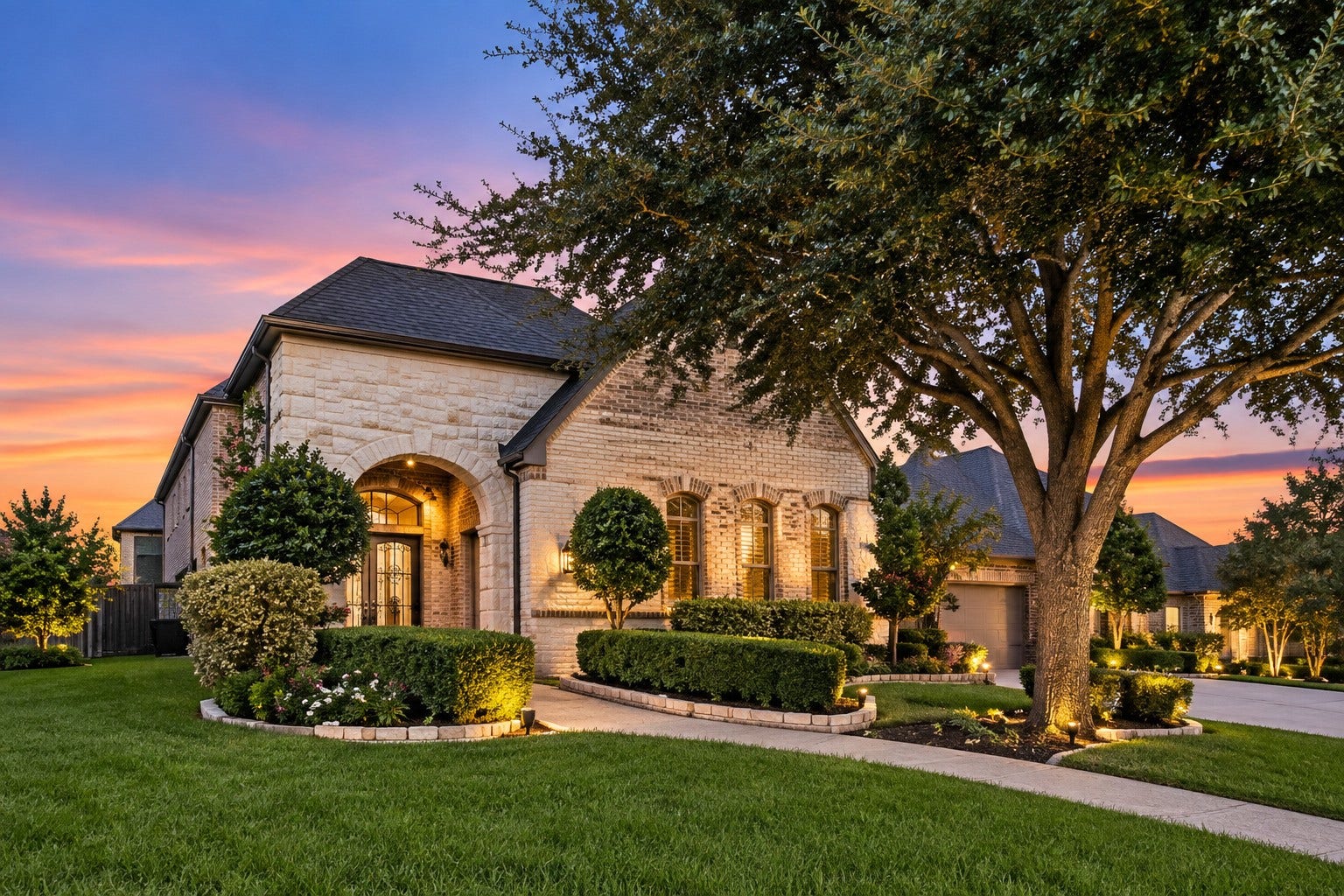 14423 Tivoli Drive, Houston, TX 77077 A distinctive stone-and-brick facade features a gated courtyard entry, manicured landscaping and warm architectural lighting.
