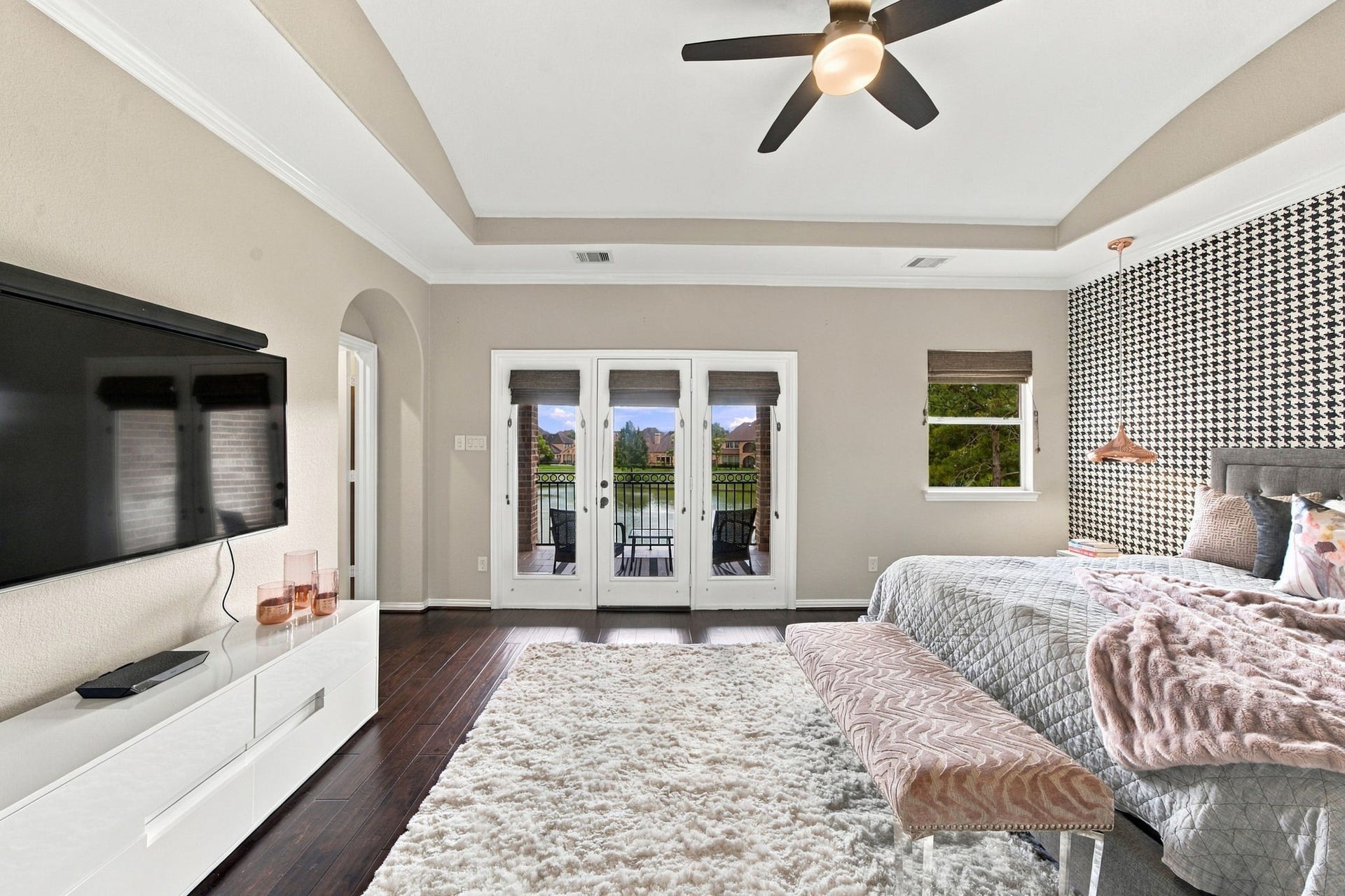 14423 Tivoli Drive, Houston, TX 77077 French doors connect the spacious primary bedroom to a private covered balcony with serene lake views.