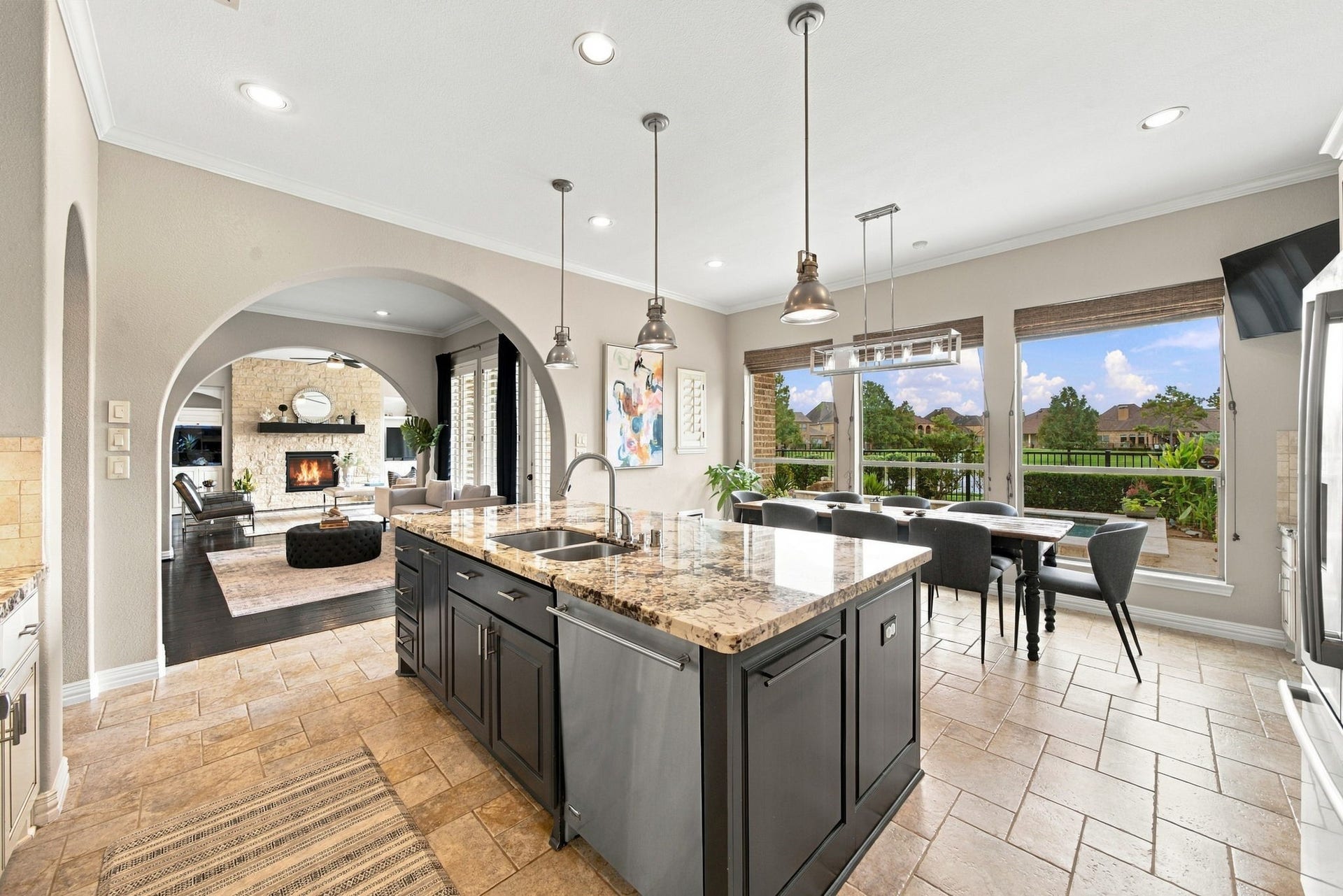 14423 Tivoli Drive, Houston, TX 77077 The open kitchen centers around a generous granite island with ample storage, stainless-steel appliances and seamless flow to the dining and living spaces.