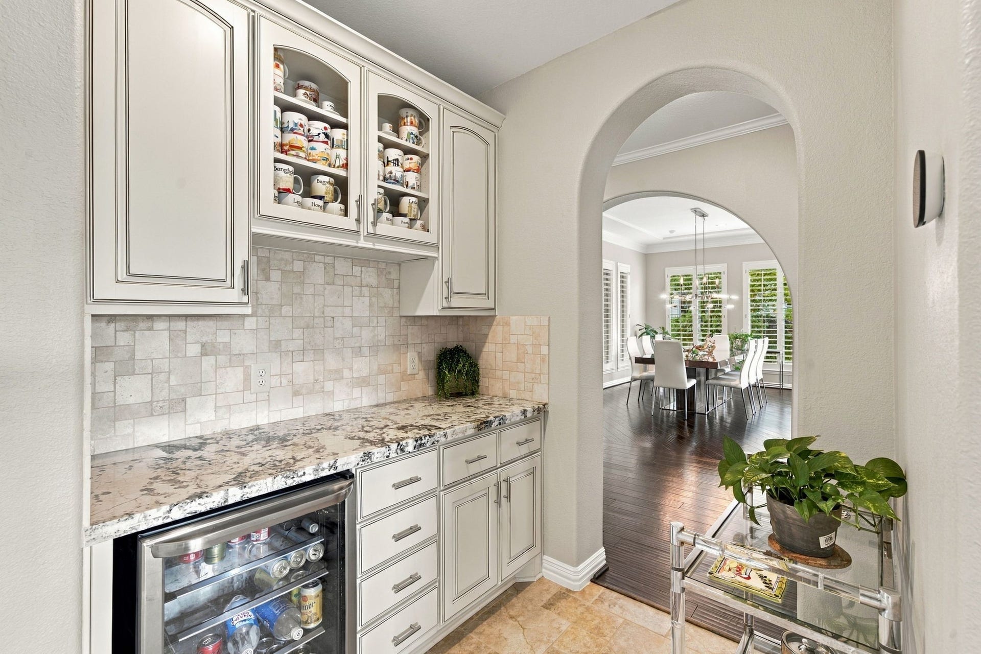 14423 Tivoli Drive, Houston, TX 77077 A convenient butlers pantry provides extensive cabinetry, a granite serving counter, display storage and a built-in beverage refrigerator.