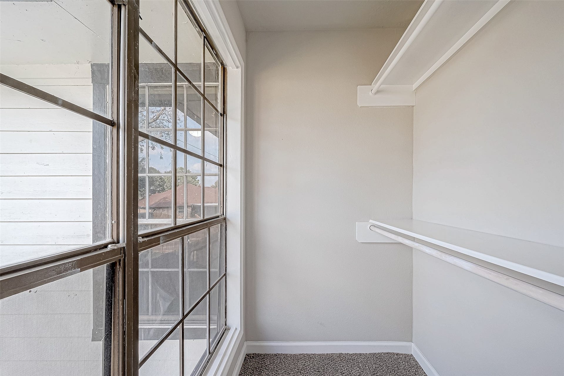 3102 Glenn Lakes Lane, Missouri City, TX 77459 Walk-in closet with large windows and built-in shelves, offering abundant natural light and ample storage.
