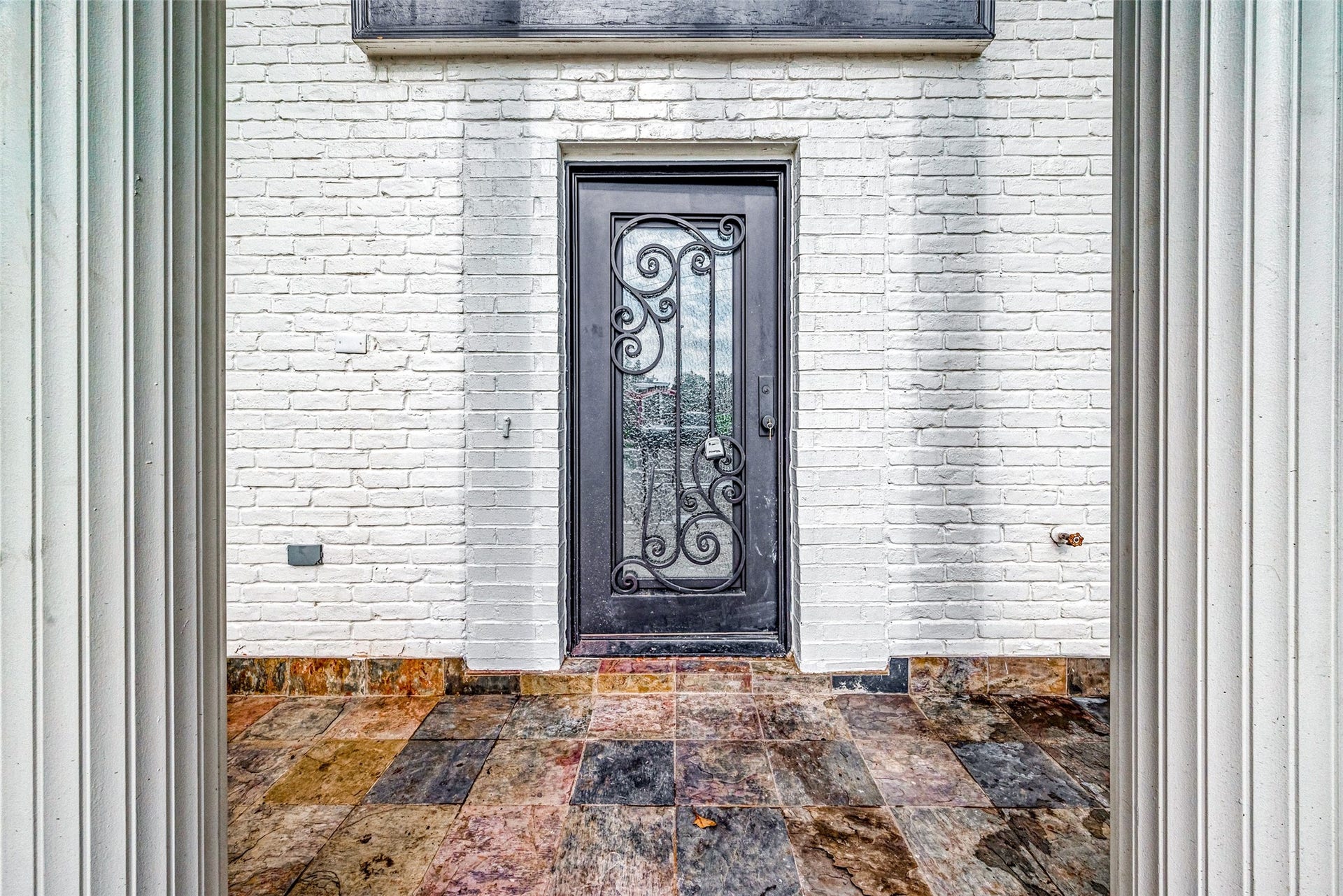3102 Glenn Lakes Lane, Missouri City, TX 77459 Elegant entrance with a black wrought iron door.