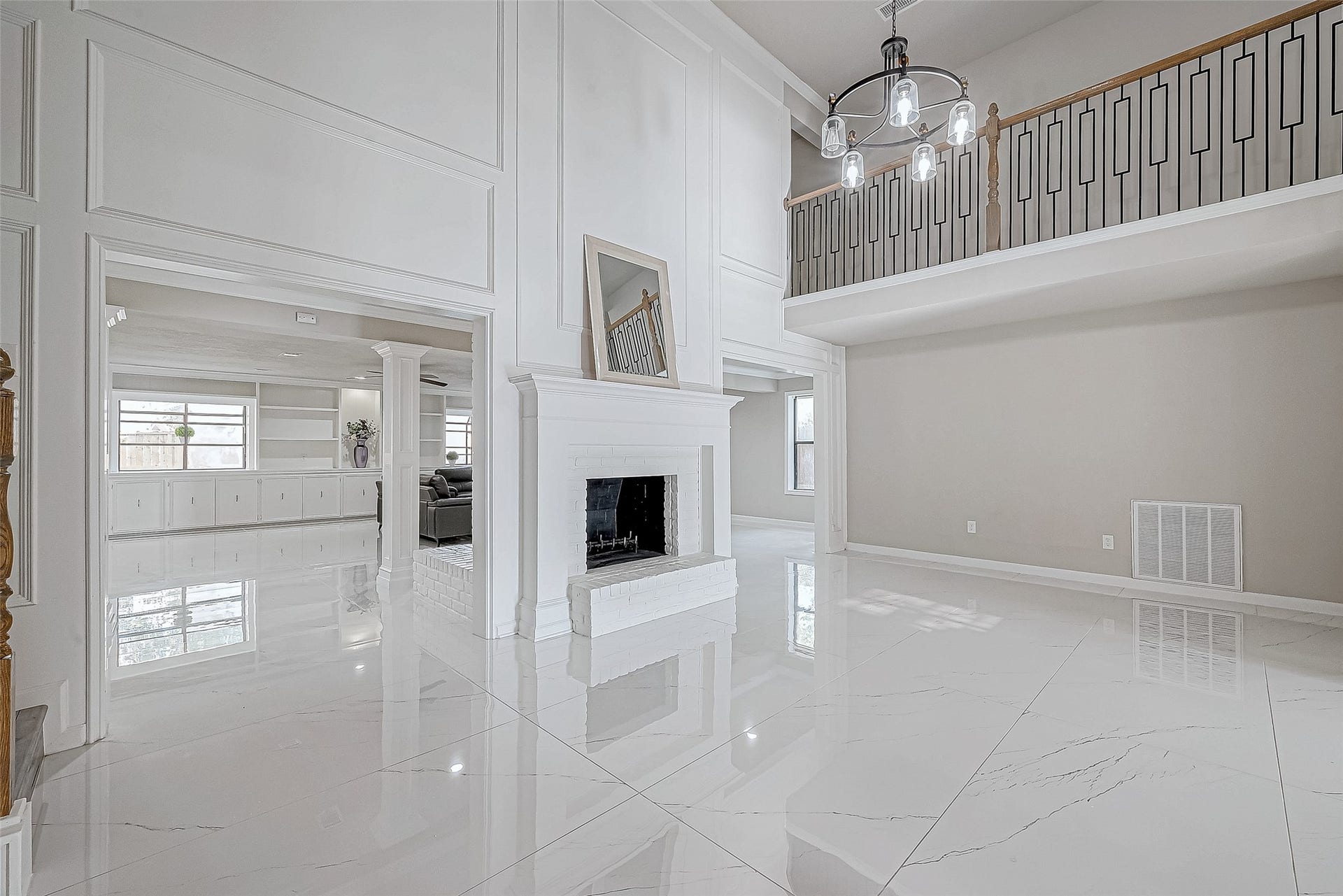 3102 Glenn Lakes Lane, Missouri City, TX 77459 The living area features a central fireplace that adds warmth, while the open layout connects seamlessly to adjacent rooms.