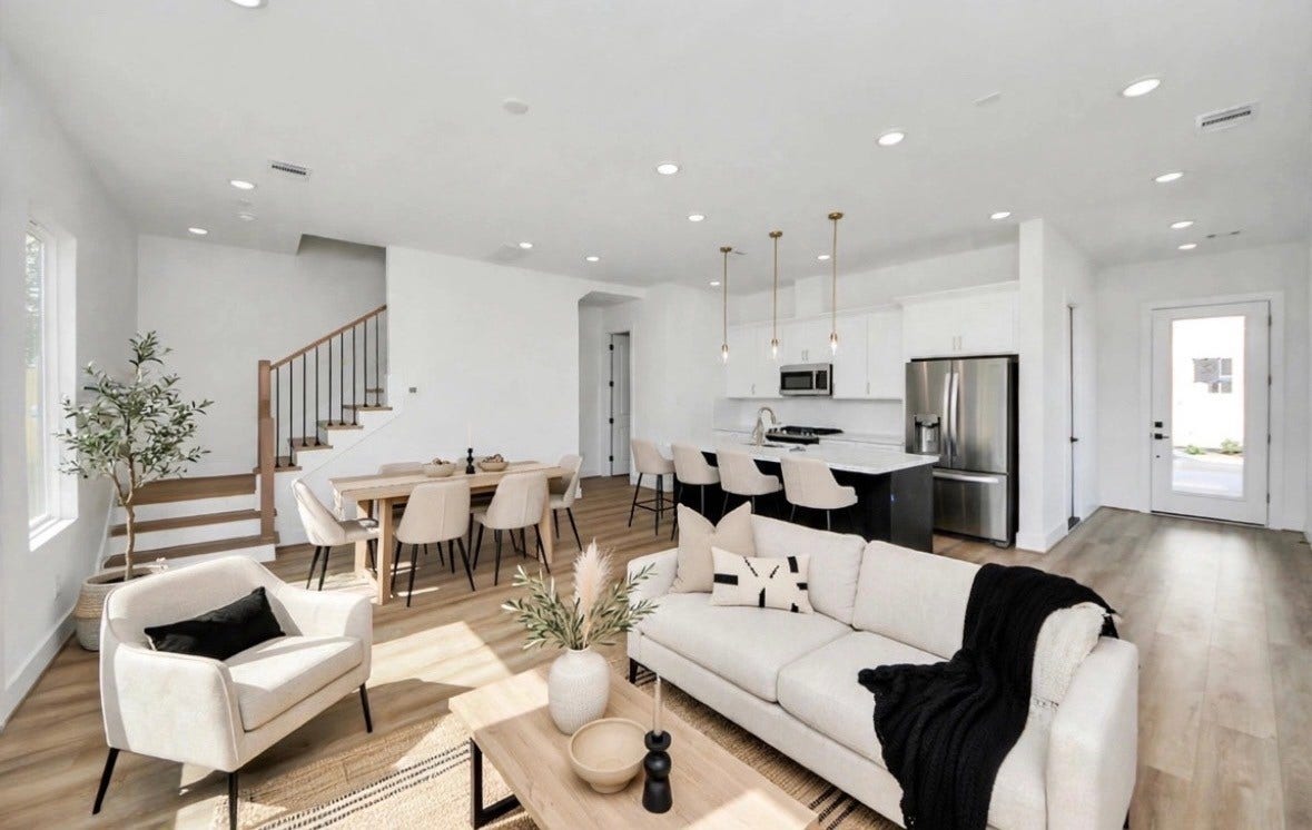 2428 Harrington Street, Houston, TX 77026 Open-concept living space with light floors and walls, accented by pops of black for a sleek, elevated modern look. The clean design and open layout create a bright, spacious feel.