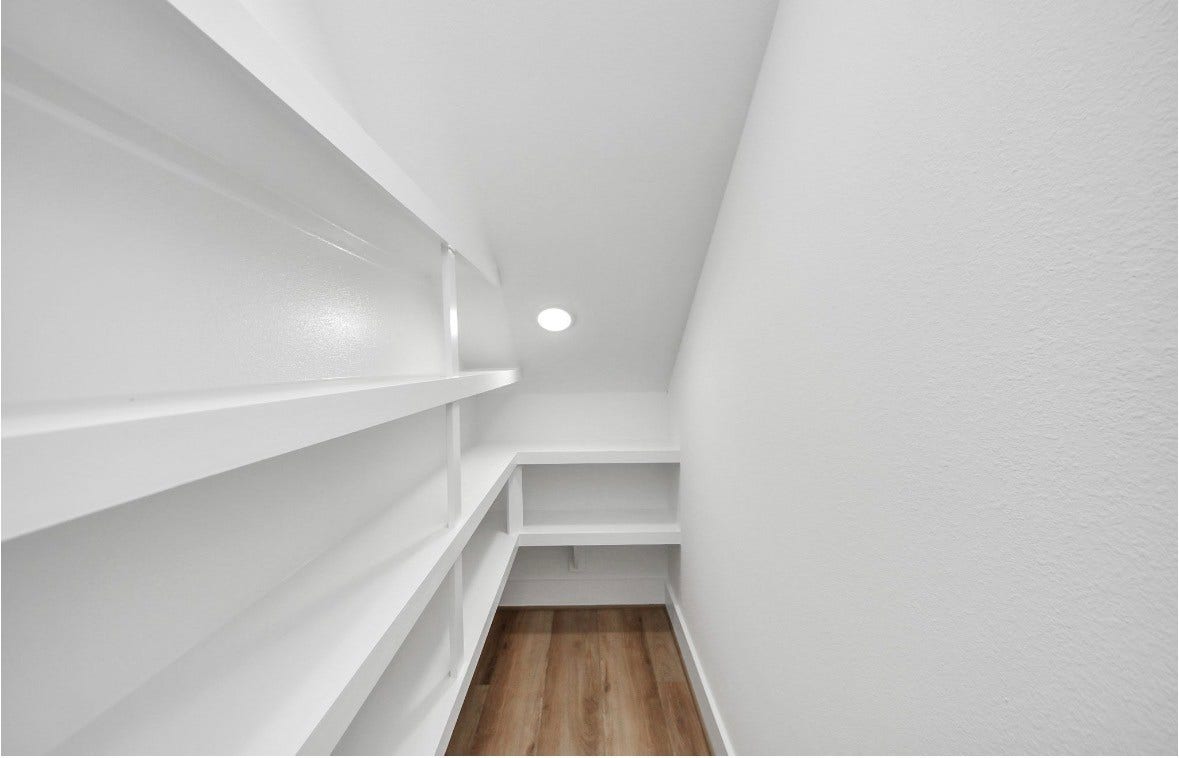 2428 Harrington Street, Houston, TX 77026 Spacious kitchen featuring a large island, perfect for meal prep, entertaining, and everyday living. Refrigerator is included with the home. Photos are from a separate model home, so furniture and decor may vary.