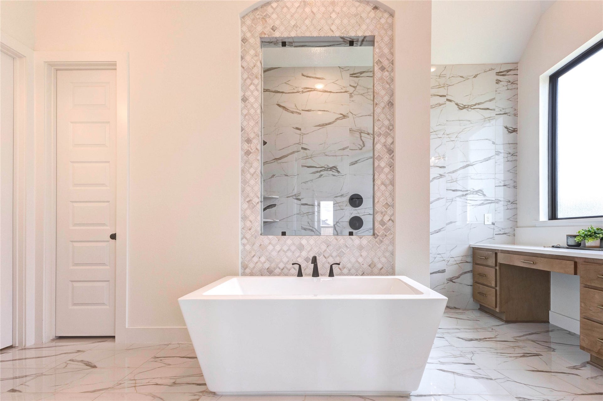 4510 Windmill Landing Lane, Fulshear, TX 77441 Soaking tub and spacious shower with modern fixtures and sleek tile. This description highlights the luxurious features of the bathroom, emphasizing both comfort and contemporary design. The combination of a soaking tub and a spacious shower caters to different preferences, while the mention of modern fixtures and sleek tile suggests a stylish and well-maintained space.